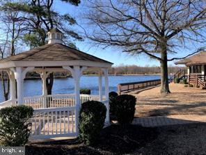 Just minutes from the Promenade or the Rt 70 & 73 intersection, this first floor end unit condo features 2 bedrooms and 2 full baths; perfect for singles, young families or seniors.  It features lots of recessed lights, an open floor plan, vinyl plank flooring, plus so many recent upgrades; you won't have to do a thing.  Step into the Foyer and notice the Vinyl Plank Flooring and beautifully painted neutral walls.  To the left are two bedrooms, lots of closet space and two beautifully updated baths featuring walk-in shower in one and tub & shower in the other.  As you continue into the Living Room with fireplace, you'll see an open concept Dining Room and Kitchen which will perhaps become your favorite place to spend most of your time.  The Kitchen features Stainless Steel Refrigerator, Dishwasher, Microwave, Range and Oven, beautifully painted walls and vinyl plank flooring which leads to a sliding glass door and provides access to a covered back patio and your own private retreat.  Relax while grilling in the back yard or store your bikes in your adjoining storage unit after a bike ride around the neighborhood.  Hike or jog on the walking trails, take a canoe or kayak trip on the lake, or play some golf at the Links Golf Course on Majestic Way also in Kings Grant.  Oak Hollow has tennis and basketball court facilities just a short walk away.  Right in Kings Grant you can enjoy swimming at the pool located on Connecting Drive and the kids can attend Richard Rice Elementary School which is on Crown Royal Parkway.