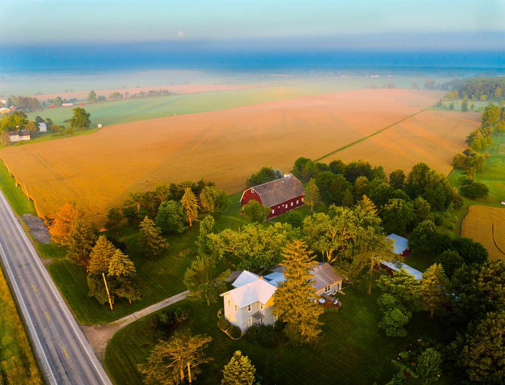 Pure rustic charm across 15 sprawling acres! The 4 bed, 3 bath, classic farmhouse offers more than 3,000 sq ft of living space where period appropriate elegance seamlessly intertwines with modern updates. The 1900's traditionally built barn offers an immense amount of functional space, historic charm, and future uses. The well maintained granary building offers similar current functionality and future potential. The 80 by 20 foot workshop features reinforced walls, a concrete floor, and a long lasting metal roof. An additional post and beam constructed shed offers another versatile workspace. Outside, you'll find expansive lawn and wooded areas, a bubbling creek, manicured gardens, and so much more.  Don't just buy a property, embrace a lifestyle that's as rich as the soil beneath your feet!