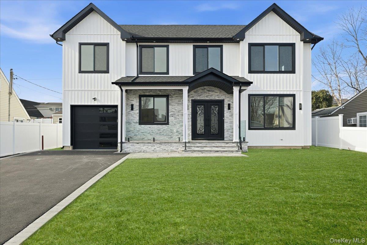 Welcome to this beautiful, brand new center hall Colonial offering the perfect balance of timeless elegance and modern comfort. The first floor is designed for both everyday living and entertaining, featuring a sun-filled great room with a fireplace that opens seamlessly to a spacious, beautifully appointed kitchen. The kitchen showcases a center island, breakfast bar, stainless steel appliances, and an abundance of natural light. Formal living and dining rooms add classic charm, while a conveniently located half bathroom completes the main level. Hardwood floors run throughout the entire home, enhancing its refined appeal.The second floor is thoughtfully designed with four generously sized bedrooms, including a large primary suite with a walk-in closet and a luxurious ensuite bathroom featuring a double vanity, soaking tub, and separate shower. One additional bedroom offers its own private full bathroom, while a third full bath serves the remaining bedrooms. A second-floor laundry room adds everyday convenience. Central air conditioning ensures year-round comfort throughout the home.The lower level features a full unfinished basement with nine-foot ceilings and an outside entrance, offering endless possibilities for future living space, storage, or recreation. Additional highlights include a one-car attached garage and a beautifully pavered yard, completing this exceptional home with style, comfort, and functionality throughout.