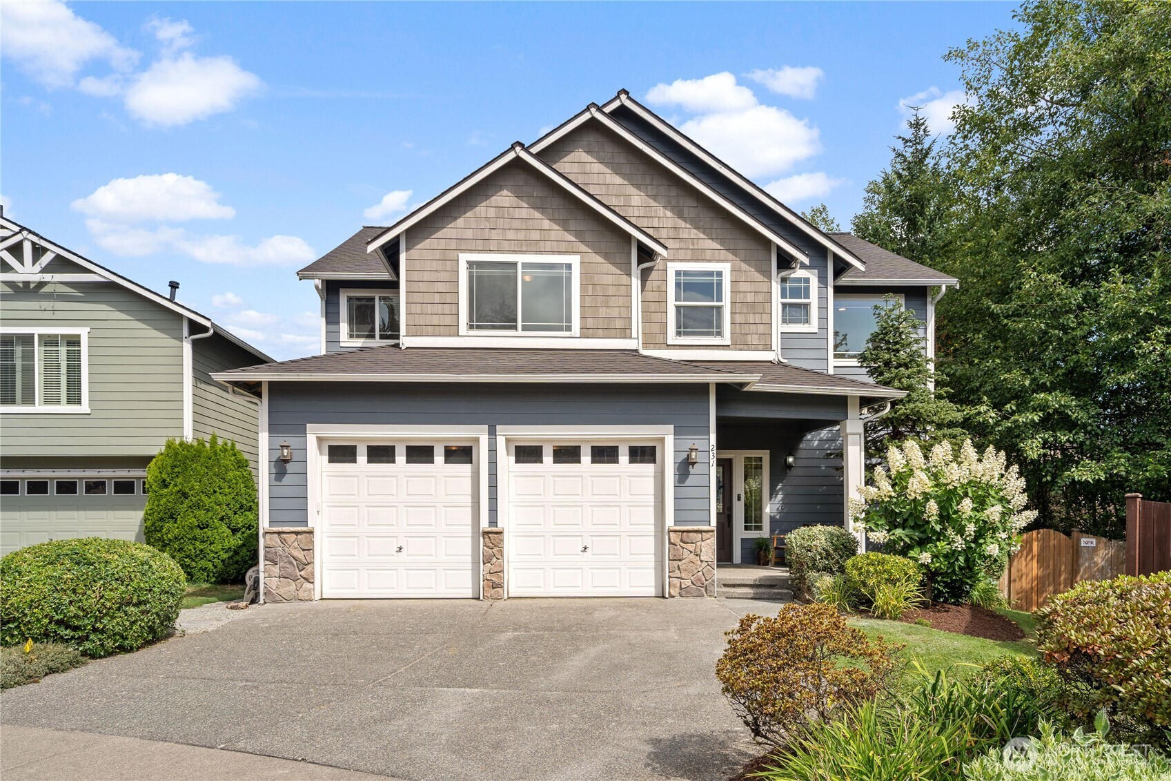 Proudly maintained, this 5-bedrm, 2.5-bath gem is truly move-in ready. Enjoy fresh interior paint, beautifully updated bathrooms, HW floors on the main level, brand-new carpet, central A/C & irrigation system in both front & backyard. Functional layout is perfect w/effortless entertaining, featuring a kitchen island, pantry, nook, & built-in desk that flow seamlessly into the living rm. Upstairs, w/a generous primary suite w/en-suite bath & lrg custom walk-in closet, w/four additional bedrm. Step outside to your own bkyard retreat—spacious & open complete w/an extended patio adjacent to a greenbelt, ideal for summer or peaceful morning coffee. All this, in the award-winning NS School District, w/quick access to I-5, I-405 & Alderwood Mall.