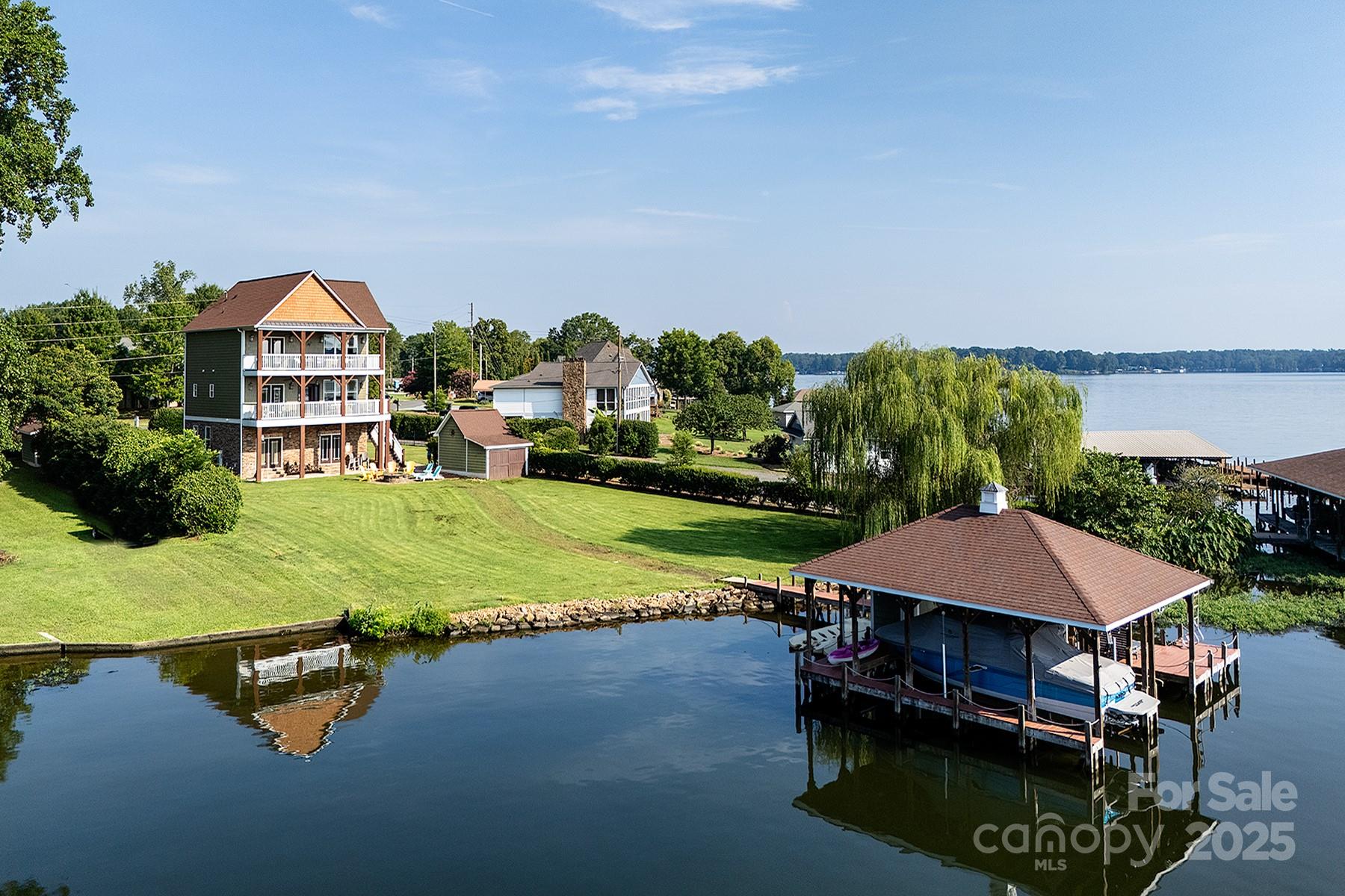 Luxury Waterfront Escape with Strong Short-Term Rental Potential! This fully furnished custom home offers 85 ft of pristine shoreline and sweeping lake views from two expansive balconies. The main level features a stylish living room with fireplace, open dining, and a well-appointed kitchen that is ideal for entertaining. The luxe Primary Suite boasts balcony access, lake views, and a spa-like bath with soaking tub. Upstairs includes one bedroom, two additional sleeping rooms, and a full bath. A spiral staircase leads to the lower level with a spacious rec room, second kitchen, and wet bar. With charm, character, and an unbeatable location, this home is perfect for lakeside living and offers excellent short-term rental income potential on top of it!