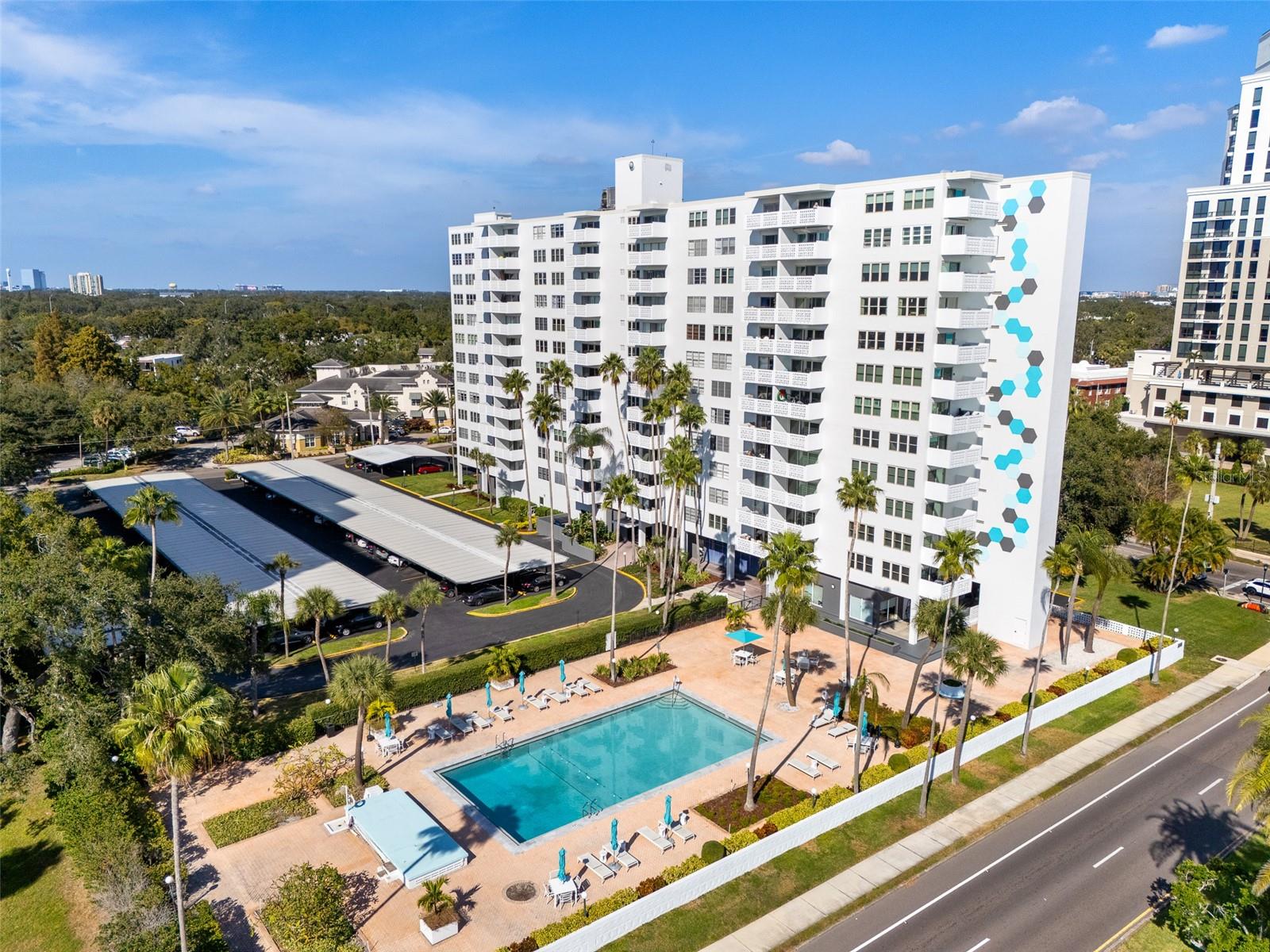 Anyone who likes retro will enjoy the aspects of this two bedroom two bath unit. It provides an excellent blend of retro and contemporary in this beautiful second floor unit at the Harbour House which remains as the best kept secret on Bayshore. Hurricane impact windows and sliders for protection from the elements, beautiful hardwood floors, very cool Smeg refrigerator to highlight the kitchen and its service bar, retro bathrooms, one with shower and the other with tub shower combination, primary bedroom with designer closet, lots of artistic touches everywhere and Bayshore views from the balcony give this home a welcoming presence, Assigned covered parking plus guest parking, onsite manager and also concierge at the front desk , beautifully restored lobby, large pool area overlooking Bayshore and so much more make Harbour House so desirable. Carport #19, extra storage in room off the lobby, front desk concierge 24/7
