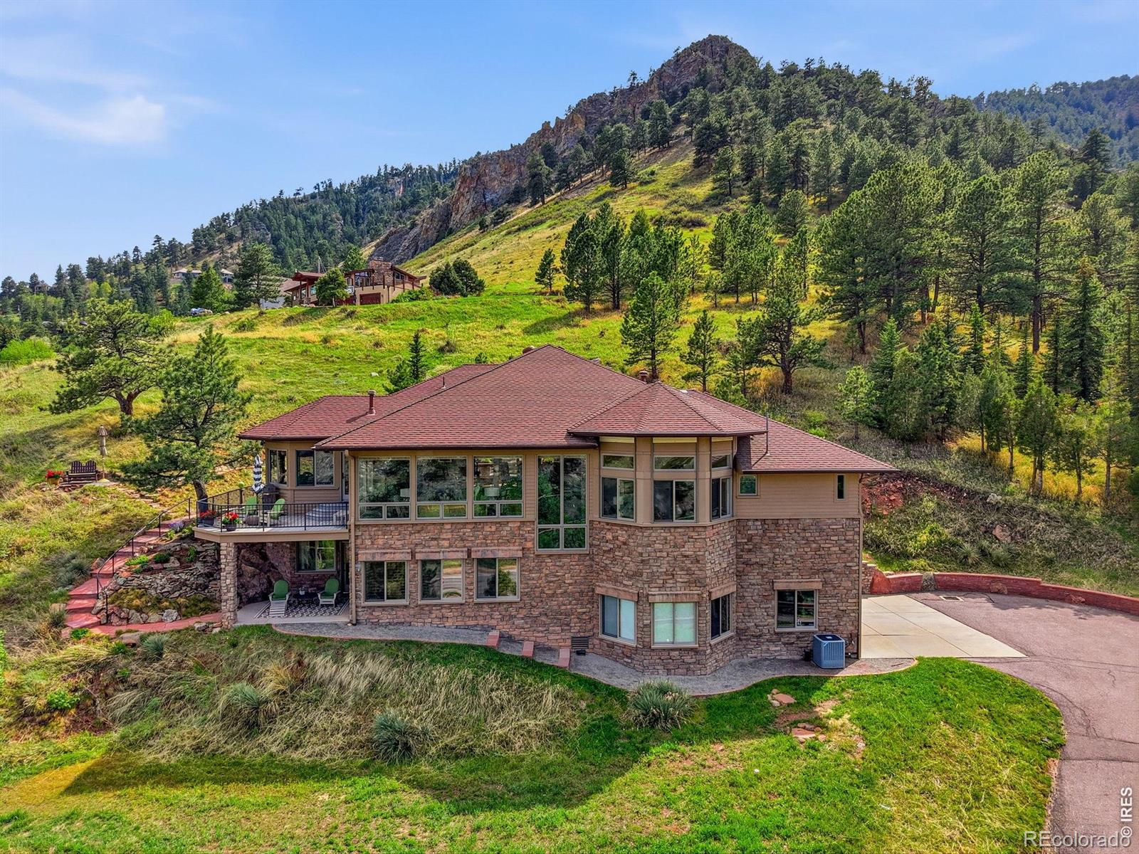 Stunning foothills contemporary in lower Pine Brook Hills, ~ 1 mile off North Broadway and just minutes to downtown Boulder. This beautiful mountain retreat offers the rare combination of privacy, views, and convenience to restaurants, coffee shops, school bus stop, and hiking on the Mount Sanitas trail system. Inside, soaring ceilings, wood floors, huge windows, and abundant natural light frame spectacular sunrise, city, reservoir, foothills, and eastern plain views from nearly every room. The open floor plan features an upgraded kitchen with custom cabinetry, luxurious lighting, and high-end appliances including Miele, Sub-Zero, Wolf, Thermador, and Asko. The main-floor primary bedroom includes a walk-in closet and recently upgraded 5-piece ensuite.Enjoy multiple outdoor living areas, including an east facing deck and a spacious patio off the dining and kitchen areas-perfect for taking in the views, wildlife, and quiet mountain atmosphere. Additional highlights include cozy baseboard heat with custom covers, WiFi thermostats and main water valve, exterior storm shutters, new boiler in 2022 and A/C in 2026. You will enjoy abundant wildlife including deer, fox, bear, golden eagles and paragliders.Private, solidly built, well cared for, and incredibly close to town-this is Boulder foothills living with lifestyle ease.