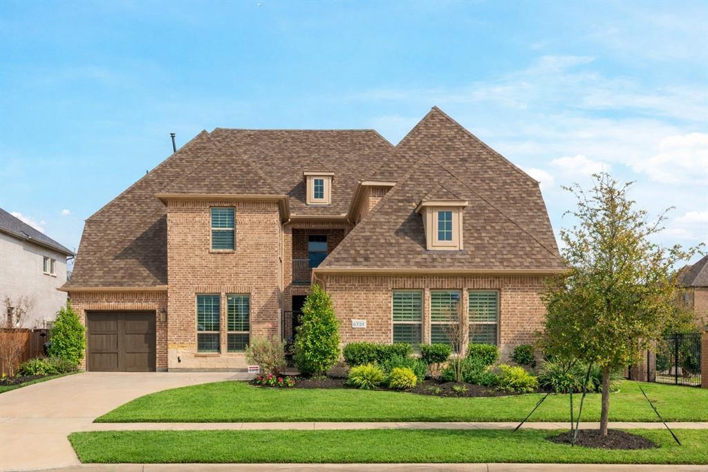 “One of the best values in Edgestone at Legacy, this Darling Homes model plan sits on a rare oversized 0.24-acre corner lot directly across from Grand Park and the Big Bluestem Trail offering privacy, views, and outdoor access that are hard to find at this price point. The neighborhood itself features walking trails, two community pools, a fully equipped gym, and outdoor spaces designed to bring residents together, creating a vibrant and active lifestyle. A private gated courtyard and custom glass front door create a striking first impression, leading into a light-filled interior with soaring vaulted ceilings, expansive windows, and a statement fireplace anchoring the main living space. Designed for both everyday living and entertaining, the open-concept layout flows seamlessly into a well-appointed kitchen featuring granite countertops, custom cabinetry, a professional-grade range, walk-in pantry, and a large island overlooking the living and dining areas. The spacious primary suite serves as a true retreat, complete with high ceilings, custom shades, and a spa like bath with dual vanities and an oversized walk-in shower. One additional bedroom conveniently located on the main level for the mother-in-law, along with a well-equipped laundry room offering custom cabinetry and added storage. Upstairs, a generous game room and dedicated media room with surround. Each secondary bedroom includes its own private bathroom, offering comfort and privacy for family or guests. The backyard offers a true extension of the home, with a covered patio for year-round comfort and a separate travertine dining terrace, creating an inviting space for outdoor entertaining surrounded by mature, privacy-enhancing landscaping. Ideally located just minutes from the Dallas North Tollway, with easy access to Legacy West, PGA, and the upcoming Universal development, this home combines space, location, community, and exceptional value in one of Frisco’s most sought-after neighborhoods.