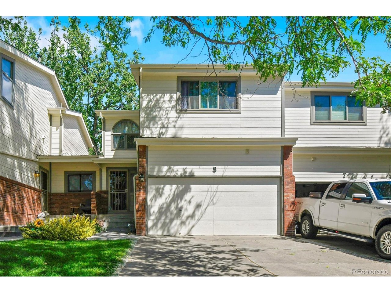 Nestled on a peaceful cul-de-sac in Arvada's sought-after Rainbow Ridge neighborhood, this beautifully maintained townhome perfectly blends comfort, style, and effortless living. Step inside to a light-filled, open-concept main level featuring gleaming hardwood floors, a cozy gas fireplace in the spacious great room, and a half bath. The thoughtfully designed kitchen boasts a large island with granite tile countertops and overlooks a bright dining area, where atrium-style windows frame views of a serene patio and lush green space. Nearby, a dedicated laundry room with new vinyl flooring and an included washer and dryer offers easy access to the finished two-car garage. Upstairs, the inviting primary suite features vaulted ceilings, dual closets, and a private bathroom with room for a soaking tub, while the secondary suite offers vaulted ceilings, double closets, a window seat, and its own private bath. The finished basement expands your living space with a large recreation room, ample storage, and a conforming third suite complete with an egress window and private bath. Updates include a high-efficiency Lennox HVAC system, newer interior paint, energy-efficient double-pane windows, and extensive 2020 HOA exterior improvements including a new roof, siding, paint, gutters, and skylights. Superbly located near parks, trails, and schools, you'll enjoy hassle-free commuting with quick access to I-70 and public transit, all while being just moments away from the vibrant dining and shops of Old Town Arvada. Add a few finishing touches and make this exceptional property your own!