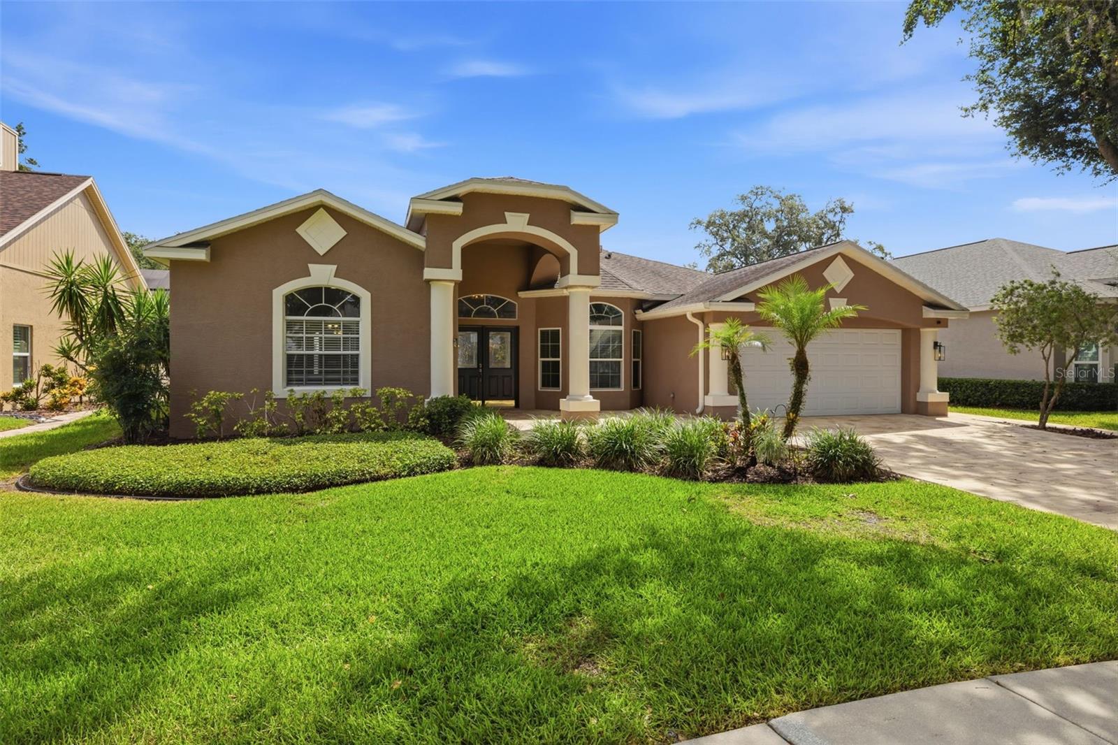 PRICE IMPROVEMENT!! Move-in ready pool home in sought-after Tampa Palms! This spacious 4-bedroom, 3-bath home features soaring ceilings, an open split-bedroom floor plan, luxury vinyl flooring throughout the main living areas, and an updated kitchen with shaker cabinetry, granite countertops, stainless steel appliances, and a large breakfast bar overlooking the family room. The oversized primary suite offers a private retreat with dual vanities, a garden tub, and separate shower.Step outside to your screened lanai and sparkling pool surrounded by a newly updated pool deck and fully fenced backyard—perfect for entertaining, pets, or enjoying Florida living year-round. Additional highlights include newer roof (2020), newer A/C (2021), a new paver driveway, mature landscaping, low HOA fees, and a location in Flood Zone X, meaning no flood insurance required!Tampa Palms is one of New Tampa's most desirable communities, offering beautiful tree-lined streets, parks, walking trails, golf, and convenient access to top-rated schools, USF, Moffitt, shopping, dining, and I-75. Schedule your private showing today!