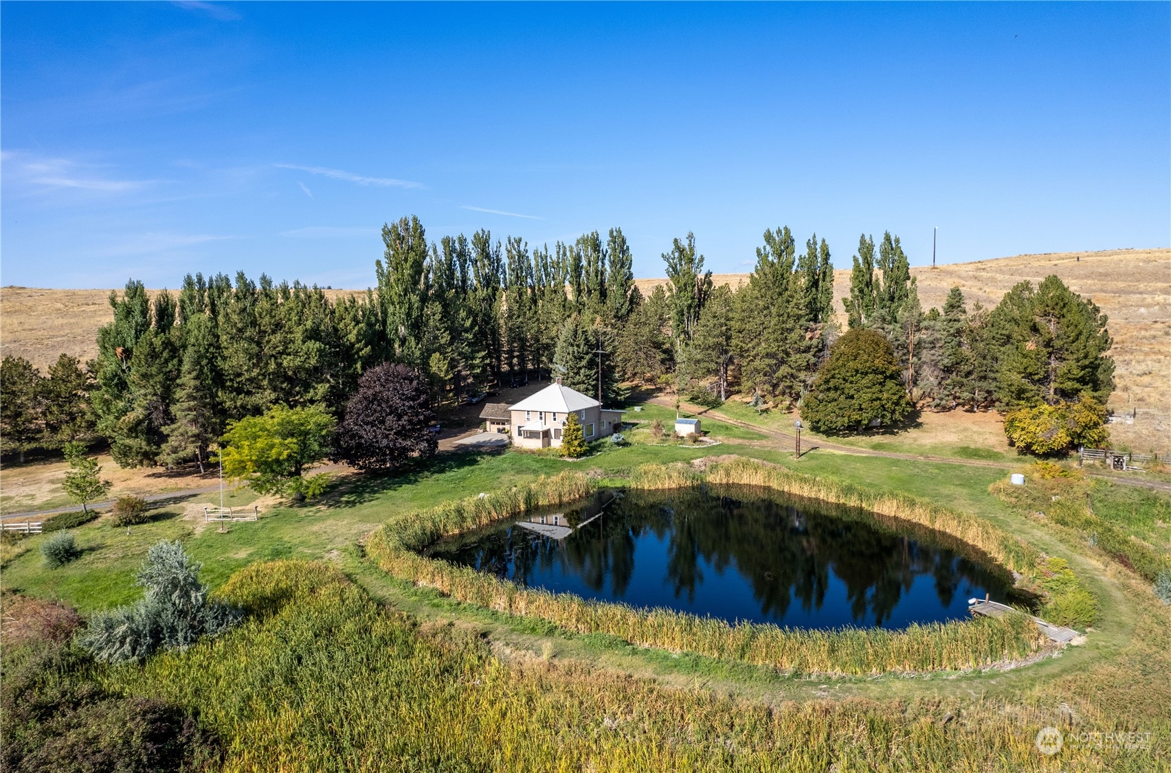 Once in a lifetime opportunity - Beautiful Douglas County Ranch containing 19 parcels totaling 5000 +/- acres. 4 bed, 2 bath home surrounded by a stunning landscape and rolling topography, with vast grassy pasture providing excellent grazing opportunities and wildlife habitat. Rudd Lake is on the property, with a stream running throughout as well. 9 total outbuildings consisting of a garage, DADU, large repair shop, hay storage, and several feeder barns. Remarkable 360-degree views and vast landscape visible from all sides of the ranch. Outstanding game and bird hunting opportunities. Thousands of acres of grazing land in a picturesque location. Come see the scenic Washington landscape today!