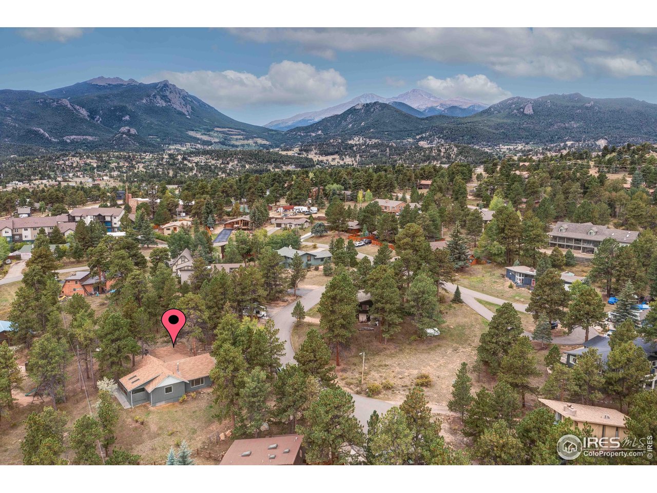 Located on a quiet cul-de-sac in popular Estes Park, this reimagined 3 bedroom, 2 bath, ranch style home offers one level living just minutes from downtown, Lake Estes, the golf course, and the entrance to Rocky Mountain National Park. Whether you're searching for a full-time residence or low-maintenance second home, this property delivers location, lifestyle, and modern updates. Inside, vaulted ceilings and new white oak hardwood floors create an open, light-filled layout. The spacious great room flows seamlessly into the updated kitchen featuring granite countertops, custom wood cabinetry, a large center island, and brand-new stainless steel appliances (oven, range, microwave, and dishwasher). The open-concept design makes entertaining easy while maintaining comfortable everyday functionality. Set on a third of an acre, the outdoor living space is equally compelling. A wraparound deck and covered patio create multiple areas for dining, relaxing, and enjoying Colorado's mountain lifestyle. Wildlife sightings, including elk, are common, offering the authentic, every day life in Estes Park experience. Recent improvements include fresh interior paint, updated windows, new entry door, wood flooring, trim, plumbing and electrical upgrades, add move-in-ready peace of mind. The primary suite offers privacy and relaxation with an oversized soaking tub. Two additional bedrooms provide flexible space for guests, remote work, or hobbies. If you're looking for a lovely move-in-ready mountain home in Estes Park near hiking trails, national park access, downtown amenities, and year-round recreation, this property checks every box.