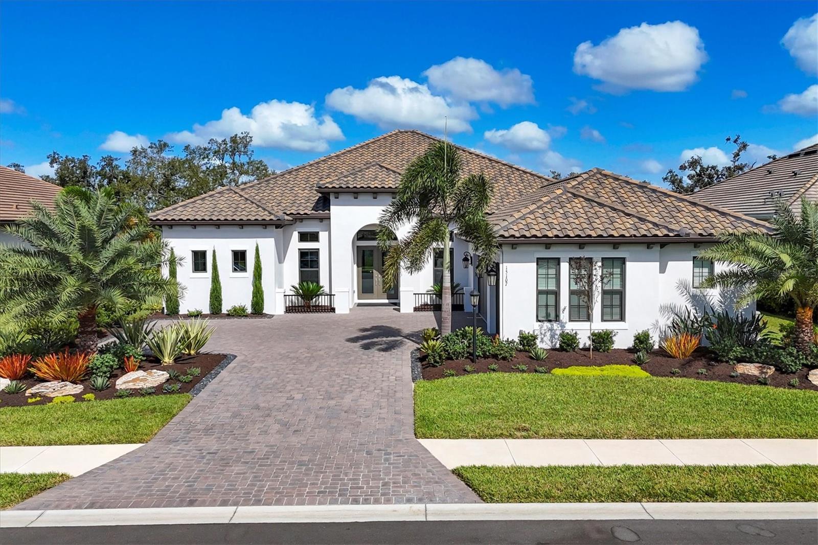 This sought-after Beacon floor plan—no longer offered by the builder and the largest single-story home available in Azario Esplanade—presents an extraordinary opportunity to own one of the community’s premier residences that is golf deeded, which includes golf membership. Set on an oversized 90-foot homesite, among the largest in the neighborhood, this three-bedroom, 3.5-bath estate was built by Taylor Morrison and features a private office, spacious bonus room, and a large resort-style pool for effortless indoor-outdoor living. Beyond the elegant double glass entry doors, an airy, light-filled floor plan unfolds with 12-foot soaring tray ceilings, architectural detailing, designer lighting and wide-plank porcelain tile floors throughout. A separate formal dining room sets the stage for holidays and entertaining, while the chef’s kitchen impresses with custom cabinetry, a luxury Monogram appliance package, quartz countertops with an oversized island, a walk-in pantry, and a casual breakfast nook overlooking the lanai. The expansive primary suite serves as a retreat, offering spacious walk-in closets and a spa-inspired bath with dual vanities and an oversized walk-in shower. The two private guest suites each feature en-suite baths. Thoughtful functionality for daily living is provided by a large bonus room, a dedicated office with French doors, an additional half bath, a well-designed laundry room with built-in cabinetry and counter space, and an organizational drop zone. Designed for seamless indoor-outdoor enjoyment, the home’s sprawling lanai features a fully equipped outdoor kitchen, panoramic screen enclosure, and a sparkling pool overlooking the tranquil backyard—fence-ready if desired. Kevlar automatic screens add privacy and storm protection at the touch of a button. Additional highlights include dual air-conditioning systems for year-round comfort, an oversized three-car side-entry garage with generous storage and a whole-house generator for peace of mind. Residents of Azario Esplanade enjoy a world-class resort lifestyle with a championship golf course, full-service clubhouse, resort-style pool, state-of-the-art fitness center, tennis and pickleball courts, spa services, the Bahama Bar with poolside dining, a gourmet culinary center and The Venue event space—all just minutes from the vibrant dining, shopping and Gulf Coast beaches that make Lakewood Ranch one of Florida’s desirable places to live.