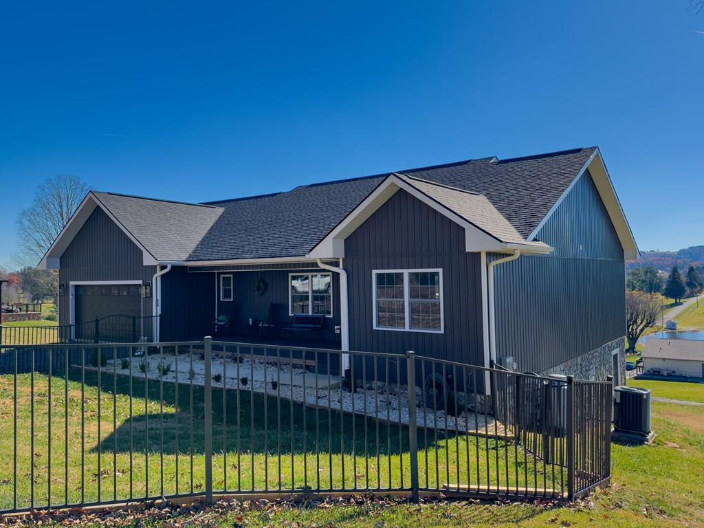 Welcome to 24 Fairway Village, an exceptional 5-bedroom, 4-bathroom home ideally positioned along the fairways of Blue Ridge Country Club. Built in 2022 and offering 3,600+ square feet of beautifully designed living space, this property combines modern comfort with stunning natural scenery, creating a lifestyle that's truly hard to beat.  From the moment you arrive, you'll appreciate the home's setting in one of the most desirable neighborhoods in the area—quiet, well-kept, and perfectly tucked against the golf course. Inside, the spacious open layout is filled with natural light and framed by golf course and mountain views that make everyday living feel like a retreat.  The main level features a generous living area with gas logs, an inviting kitchen with modern finishes including beautiful quartz countertops and a dining space overlooking the fairway. The spacious laundry room on the main level offers convenience and features a dog wash station to keep your companions clean with ease. Step out onto the covered deck, the perfect spot for morning coffee, grilling, or simply taking in the remarkable scenery that surrounds the home.  With five large bedrooms, including a relaxing primary suite, there's plenty of room for family, guests, or flexible spaces such as an office or hobby room. The full basement adds even more potential—whether you envision a game room, home gym, media space, or additional storage.  With nearly 10 foot high ceilings the potential is unlimited in this space. A convenient garage makes day-to-day living easy, and the home's newer construction means low maintenance and modern efficiency throughout.  Whether you love golf, beautiful mountain backdrops, or the peaceful setting of a premier neighborhood, this home delivers it all. With direct access to the course and views you won't find anywhere else, 24 Fairway Village is a rare opportunity to enjoy luxury, space, and location in one perfect package.