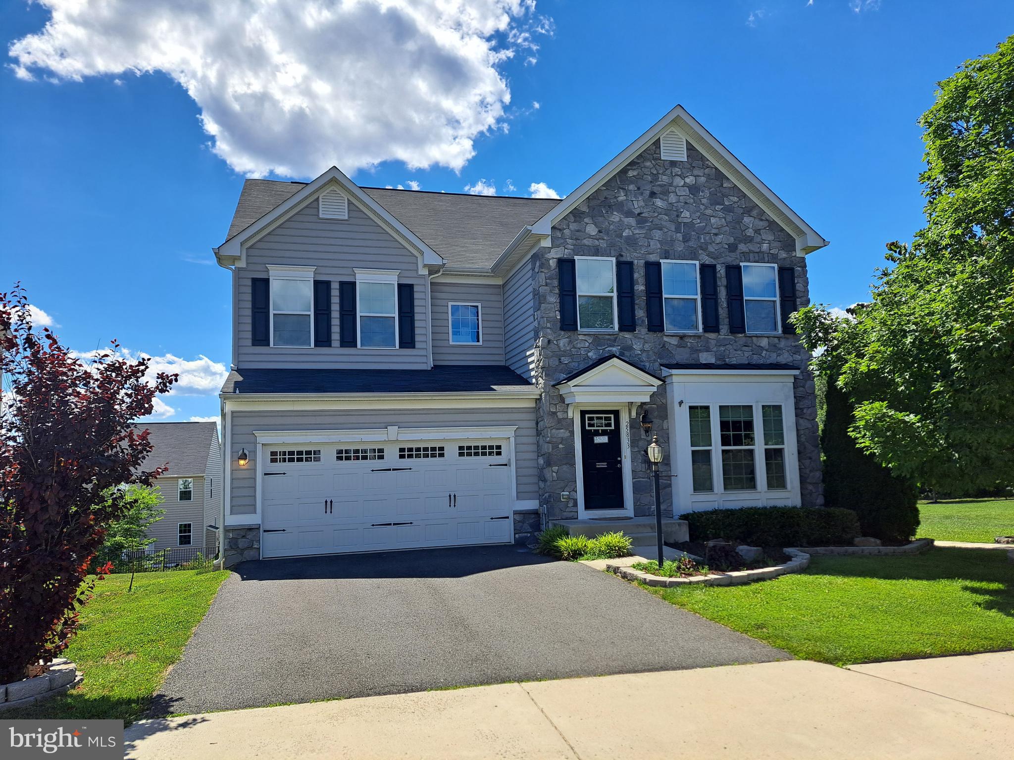 Welcome to this stunning Torino model in the highly sought-after Virginia Manor community, perfectly situated on a premium end-of-block lot. With over 5,293 finished square feet, this impressive Ryan Homes floor plan is one of the largest in the neighborhood and offers an exceptional blend of luxury, comfort, and functionality.The beautiful stone-front exterior and covered portico create outstanding curb appeal. Inside, the open-concept floor plan is ideal for both everyday living and entertaining. A spacious mudroom leads to an oversized pantry and gourmet kitchen featuring newer appliances, double wall ovens, a massive granite island with abundant storage, and a convenient sitting area. The kitchen flows seamlessly into the bright two-level morning room extension with cathedral ceiling and opens to a large deck—perfect for enjoying morning coffee or evening gatherings.The main level also features tile flooring throughout, a private office, formal living room, and a large great room anchored by a cozy stone fireplace. Upstairs, the luxurious primary suite offers a tray ceiling, two expansive walk-in closets with custom organizers, and a spa-like bath with dual vanities, soaking tub, and separate shower. A convenient bedroom-level laundry room serves all four bedrooms. One secondary bedroom features a private en-suite bath, while two additional bedrooms share a full hall bath. All secondary bedrooms include customized closet storage systems.The finished walkout lower level is filled with natural light and includes a spacious recreation room, full bathroom, and morning room extension with full-size windows. Luxury vinyl plank flooring enhances the lower level's appeal.Additional features include a large two-car garage, crown molding, ceiling fans throughout, energy-efficient upgrades, irrigation system, rear access sidewalk, and abundant storage throughout the home.Virginia Manor offers outstanding community amenities, including 14 parks connected by scenic walking trails, four tot lots, and access to two large swimming pools. Conveniently located near shopping, Route 50, Braddock Road, and Gum Spring Road, this exceptional home combines luxury, space, and convenience in one of the area's most desirable communities.
