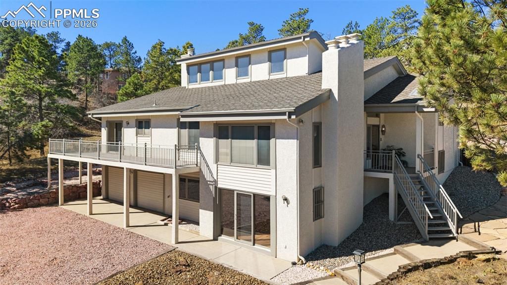 Almost 1 Acre in Town! 5 bedroom, 3.5 bath custom passive solar custom home! This house has tons of hardwood and new flooring! Large wrap around deck overlooks the city and beautiful natural scape! This house was built for entertaining with large great room with soaring ceilings, huge gourmet kitchen with quartz counter tops, wood floors, eat in area and connects with family room featuring a wood burning fireplace and walks out to wrap around deck. Formal Dining room has tall ceilings with city views, formal living room boasts a gorgeous masonry fireplace mantle, tall ceilings, and wood floors! Upper level has 3 bedrooms including the master bedroom suite with vaulted ceilings, private walk out patio, huge master bath with jetted tub and separate shower and walk in closet with built in shelving. 2 additional bedrooms are spacious, have wood flooring and share a full bathroom. Lower level has a full size laundry room with gas hookups and huge guest room that has wall to wall closet space! Could be converted to a dream office or hobby room! Walk out basement offers a huge rec room with walk out door, wet bar and wood fireplace! 5th bedroom is in the basement and has a 3/4 bath to make a perfect guest area! The garage is extra deep (38 feet) and has a full built in workshop with electricity and additional storage about the workshop! Could be converted to a 4 car tandem garage! This home has a lot of extras including a brand energy efficient boiler system, hot water heater, dumb waiter elevator from the garage to the kitchen, new interior paint, wall mounted air conditioner, 3 fireplaces, wrap around driveway, newer updated kitchen appliances, composite decking, and lots more! Close to I-25 and USAFA, district 20 schools, tons of trees and rock formations and extensive rock scaping around the house. Wild life and quiet all around!