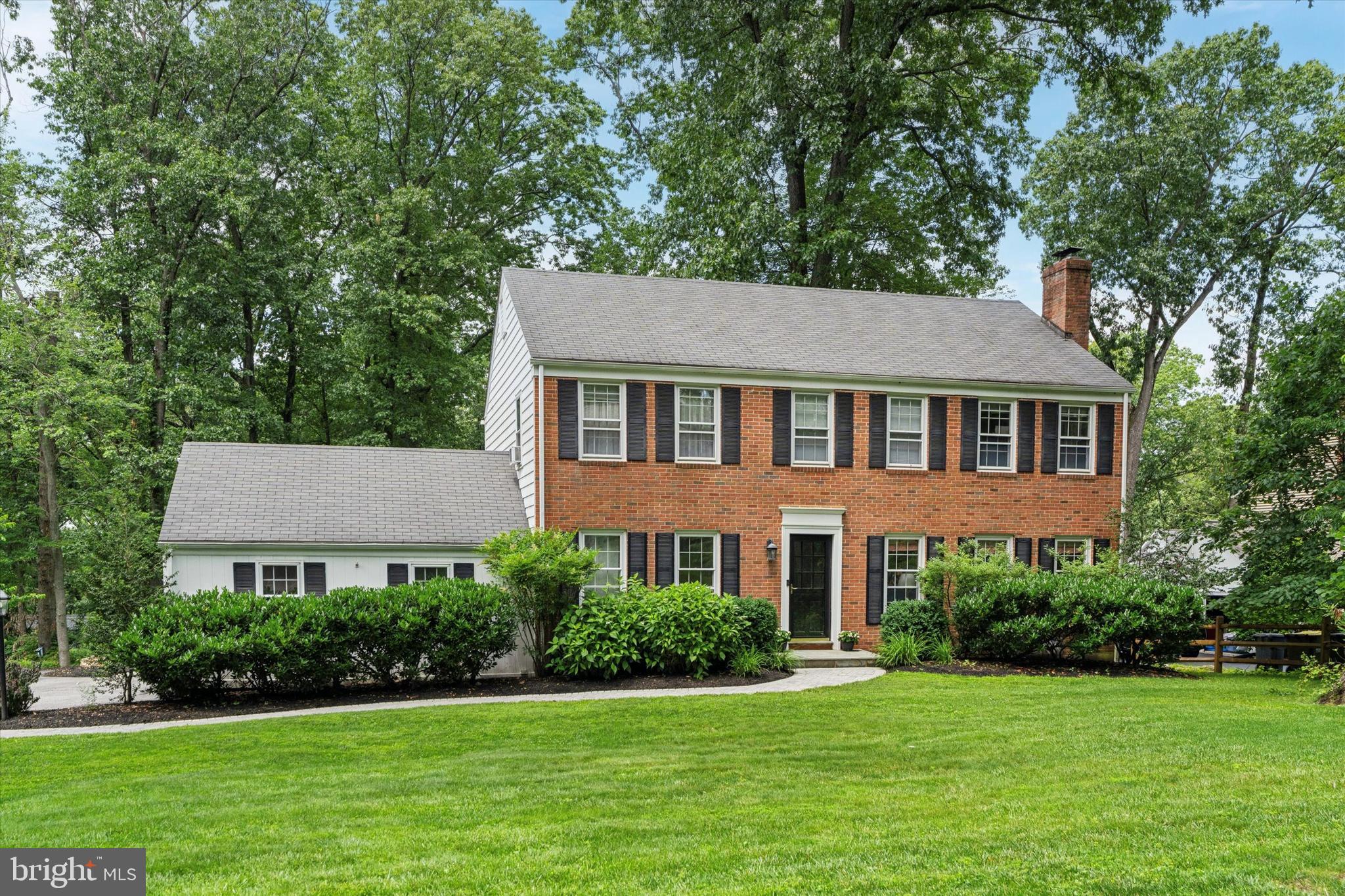 Welcome to 349 Colket Lane, a stately brick-front colonial-style home located in the heart of Wayne, where the top-rated Tredyffrin/Easttown Schools and a highly desirable location come together to create the perfect place to call home. Step inside to find a bright, updated kitchen featuring painted white cabinets, quartz countertops, and stainless-steel appliances—designed for both everyday living and entertaining. Enjoy the wood-burning fireplace in the large, light-filled living room, complete with built-in bookcases. On the first floor, you’ll also find a nicely sized dining room, a family room, and a newly updated mudroom/laundry room and a powder room. From the family room, step out to a patio featuring a cozy wood-burning fireplace. The backyard is a true retreat—perfect for crisp fall evenings or summer gatherings. Upstairs, you’ll find four spacious bedrooms, including a newly updated primary en suite with a tiled walk-in shower and a large walk-in closet. Three additional bedrooms—one with its own walk-in closet—and a hall bath complete the second level. The unfinished basement is ready to be customized to your needs, with some framing and electrical work already in place. Enjoy peace of mind with a whole-house generator, natural gas connection, and updated mechanicals, including HVAC, electric panel, and a hot water heater. Beautiful original hardwood floors run throughout the home, ready to be refinished in the style that suits you best. All of this, just minutes from shopping, dining, and community amenities in downtown Wayne and King of Prussia, with quick access to major roadways including Route 202, and an easy commute to Center City via the R5 line from the Wayne Train Station.