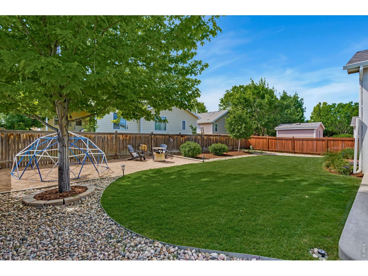 From the welcoming front porch to the beautifully landscaped backyard, this ranch home brings together inviting spaces both inside and out. Located on a quiet, tree-lined street, the home features an open layout connecting the living room, dining area, and kitchen, creating a natural flow throughout the main living spaces. The kitchen offers hardwood flooring, rich cabinetry, a center island, stainless steel appliances including a new dishwasher, and a deep stainless steel sink. Natural wood trim throughout the home adds warmth and character. The primary suite features high ceilings and a private ensuite bathroom with a double vanity and walk-in shower. Two additional bedrooms and a full bath complete the thoughtfully designed main-level layout. Outside, mature trees and landscaped outdoor spaces create inviting areas to relax and enjoy the outdoors. The unfinished basement adds 1,396 square feet of space for storage or future expansion. Other features include an oversized garage with dedicated 50-amp service currently configured for equipment or workshop use, along with a new sump pump and Nest smart thermostat. No metro district.