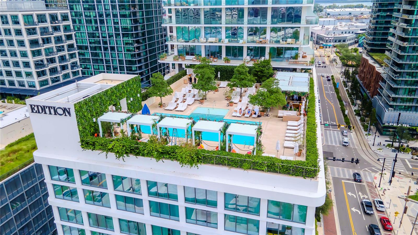An exclusive lifestyle, tailored with elegance and sophistication. Welcome to your new, luxurious home, located in the prestigious Residences at The Tampa EDITION and perfectly situated in the heart of Downtown Tampa’s renown Waterstreet district. Embrace the convenience and indulgences of city living while surrounded by Michelin-starred restaurants and bars, coffee shops, luxury retail and grocery stores, Sparkman Wharf, dog parks and the Amelia Arena, home of the Tampa Bay Lighting, Stanley Cup Champions. As you enter this meticulously Roman and Williams designed 3 bedroom, executive room, 3.5 bathroom home, you are greeted by breathtaking, panoramic city and water views framed by floor-to-ceiling windows. Featuring sleek 10”-wide plank, white oak wood floors by Grato Portugal and high-end finishes perfect for entertaining and relaxing in style. The kitchen offers Polaris White marble countertops, Molteni Italian Millwork and powered upper cabinets with ambient cove lighting, Gaggenau stainless steel kitchen appliances, including a 52-bottle wine refrigerator, wine cooler, 5-burner gas cooktop with a Miele venting hood and an oversized Polaris White marble waterfall island, making it a perfect space for culinary enthusiasts. Relax with a cup of coffee or glass of wine on your 66’ wraparound lanai with glass railings.  The Owner’s suite, with serene skyline views, offers a wardrobe room with custom cabinetry designed by California Closets, ensuite bathroom with a Polaris White marble dual vanity, mosaic marble shower and freestanding Kaldewei soaking tub. The executive room functions as a fourth bedroom, office/den or may be converted into second wardrobe room. The powder room offers pristine Venetian plaster walls and each guest room features custom-designed closets by California Closets and an ensuite bathroom with a Polaris White marble vanity, bathtub and shower. Residents at the Tampa EDITION enjoy dedicated and tailored services, inclusive of an exclusive resident driveway with valet services, dedicated residential garage with assigned parking spaces, social kitchen and lounge, an on-premises lifestyle manager, a residents-only gym and 24-hour security and concierge services. Indulge in unique experiences and dining at the Tampa EDITION’s Michelin-starred restaurants, overseen by Michelin-starred chef, John Fraser, stunningly designed bars, resort-style pool with full food and beverage services, a tranquil full-service spa, quaint seating areas with luscious foliage and more. This exquisite home is one-of-a-kind and truly a must see!