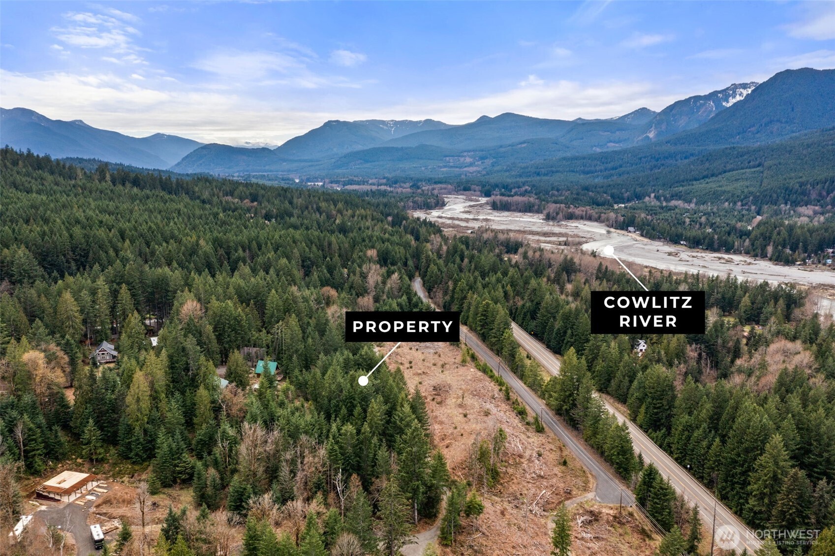 Prime NW development opportunity in the sought-after TIMBERLINE COMMUNITY in Packwood. This beautiful 3.31-acre property is partially cleared with level building areas tucked against a forested hillside and features Northwest mountain views. Lot to the west was recently cleared to prepare for building, opening up views from this property. Seller nearly completed a 3-lot short plat (final approval previously delayed by water moratorium). Now with 3 WATER HOOKUPS paid and ready, road upgrades completed for three lots, and power installed, it’s primed for development. Build three luxury homes with ADUs, create a private estate, or divide and resell. Enjoy Timberline amenities—pools, tennis court, playground, clubhouse—and close proximity to Mount Rainier National Park, White Pass Ski Area, and endless year-round recreation.