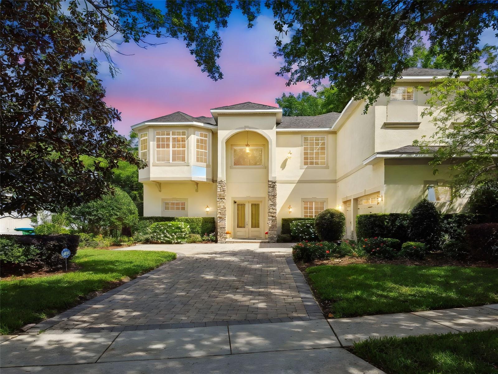 One or more photo(s) has been virtually staged. NEW PRICE! Discover your private oasis in the heart of Maitland, perfectly tucked away on a quiet cul-de-sac within an exclusive gated enclave of only 19 custom homes. Ideally positioned between Lake Sybelia and Lake Catherine, this one-owner estate blends timeless sophistication, modern comfort, and exceptional livability. With five spacious bedrooms, four-and-a-half baths, and a three-car garage, the home showcases soaring ceilings, elegant architectural details, and an open, flexible layout designed for today’s lifestyle. The gourmet kitchen features solid wood cabinetry, a large island, new refrigerator, walk-in pantry, and dual breakfast bars flowing effortlessly into the formal dining and family rooms, where a cozy gas fireplace and custom wet bar create the perfect space for entertaining. Thoughtfully designed for multigenerational living, the residence includes two private wings—one featuring a complete in-law suite with full kitchen, expansive living area, bedroom, bath, and private entrance. Upstairs, the luxurious owner’s retreat offers a loft-style office and sitting area, dual walk-in closets, and a spa-inspired bath. Step outside to a lush tropical paradise where a sparkling saltwater pool with new equipment, papaya trees, and blooming amaryllis create a serene, resort-style ambiance. Additional highlights include a new roof (2023), first-floor laundry with newer appliances, tray ceilings, archways, and low HOA fees. Just minutes from top-rated schools, parks, restaurants, Park Avenue, Hannibal Square and the Winter Park Village, with scenic walkability or a bike ride along Lake Sybelia to local cafés, the Sunday Farmers Market, and the Maitland Art Museum, this exquisite home offers the rare combination of privacy, sophistication, and convenience in one of Central Florida’s most sought-after communities. Schedule your private showing today and experience the extraordinary lifestyle this Maitland masterpiece provides.