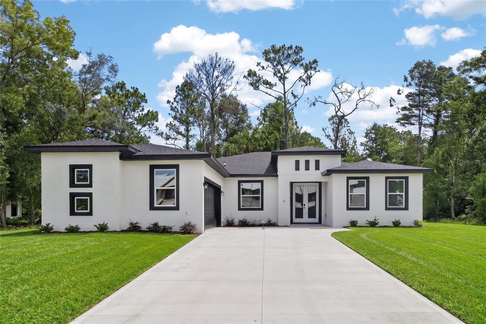 Seller is offering up to $5,000 toward closing costs! Welcome to this stunning new construction home in Homosassa, where refined design meets everyday comfort. Offering four bedrooms, three baths and 2,406 square feet of living space, this home features an open-concept layout built for elevated living. The gourmet kitchen boasts soft blue-gray cabinetry, sleek white quartz countertops, stainless steel appliances, and a spacious island flowing into the living and dining areas, a striking, move-in-ready color palette ideal for everyday life and entertaining. The split floor plan offers privacy, with a generous primary suite and beautifully appointed en-suite bath. On an exceptional 0.28-acre lot, one of the finest in the area, there's ample room to create your outdoor retreat. The location is unmatched, just two minutes from Sugarmill Woods Country Club's renowned golf course, and moments from shopping, dining, outdoor recreation and famous Homosassa Springs. Schedule your private showing today.