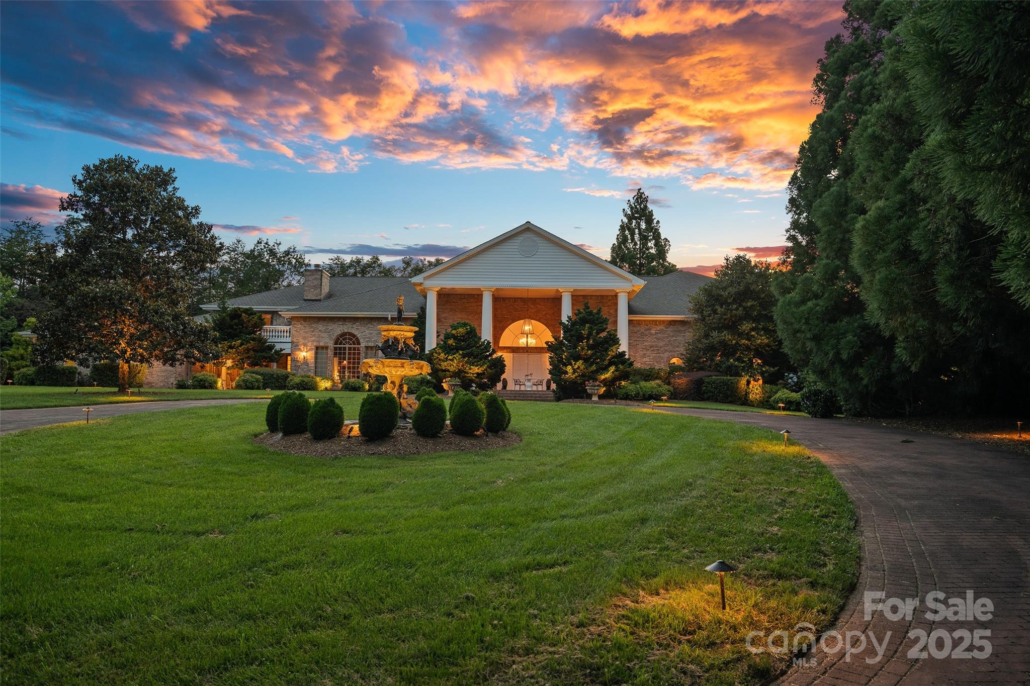 Welcome to Le Chêne D’Or, an exceptional private estate spanning more than 14 acres in the prestigious Equestrian Estates community. Enveloped by manicured grounds with a tranquil pond, waterfall, and direct access to FETA riding trails, this residence captures the romance and refined sophistication of classic European architecture.

From the moment you pass through the gates and approach the circular drive framed by a bronze fountain, every detail evokes elegance. The grand front porch opens to a soaring foyer with 20-foot ceilings, bathing the interiors in natural light. Spanning over 9,500 square feet, the home offers five fireplaces, Jerusalem-stone terraces, and resort-style outdoor living with a pool and generous lounge areas ideal for both quiet retreat and grand entertaining.

The gourmet chef’s kitchen features a Sub-Zero refrigerator, gas range with custom hood, large island with prep sink, and a sunlit breakfast room overlooking the waterfall, all seamlessly connected to a warm great room with a fireplace and wet bar. The living room’s floor-to-ceiling windows frame sweeping views of the terrace and landscaped grounds.

The primary suite is a true sanctuary, with its own fireplace, built-ins, dual custom closets, and a spa-inspired bath featuring cultured-marble vanities, jetted tub, and walk-in shower. Each additional bedroom offers a private ensuite. A richly detailed office, private upper-level room with Juliet balcony, and a lower-level entertainment area with full bar, billiard room, and flex space complete the interior.

Additional highlights include an air-conditioned storage area, four-car garage, and proximity to premier destinations such as Tryon International Equestrian Center, Lake Lure, Chimney Rock, Greenville, Asheville, local airports, vineyards, and scenic parks, all within the rolling foothills of the Blue Ridge Mountains.

Le Chêne D’Or is more than a home, it is an enduring statement of elegance, craftsmanship, and tranquility.