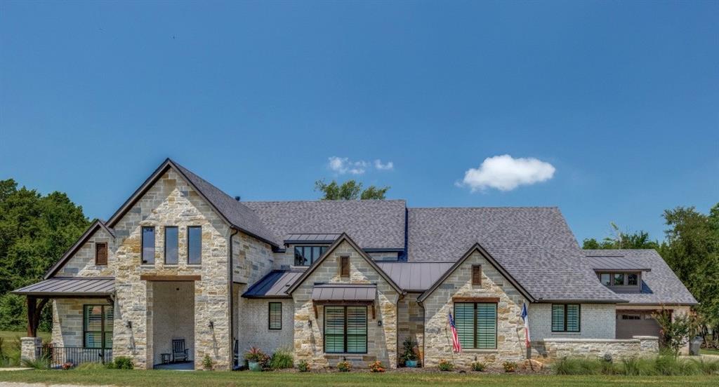 WELCOME TO YOUR DREAM LAKE FRONT PROPERTY, a Hill Country inspired modern single family home featuring 5 bedrooms, 3.5 baths across 4324 sq. ft. of living space.  This home boasts of 20 ft. entry with custom wrought iron front door, beautiful hand scraped hardwood floors throughout, a chef’s kitchen featuring a 6 burner Wolf cooktop, KitchenAid appliances including double ovens (convection), huge kitchen island with farm sink and quartzite countertops.  Expansive primary suite includes bedroom with lots of windows and a lake view, an attached gym with mirrored wall and a dry sauna, ensuite bathroom has huge walk-in shower, separate vanities and beautiful free standing tub, closet includes large custom built-in dresser and ample space, which attaches to oversized laundry room with sink and lots of storage.  Windows across back of home for amazing views of the lake.  Living room boasts of 19 ft. stone fire place.  Gorgeous study with built-in bookcase and glass French doors.  Wine cellar with built-in cabinets, wrought iron door, full wall wine rack and provisioned for built-in fridge.  Walk down the hall to the impressive game room and wet bar with fully bricked back wall and beautiful 13’ Anderson sliding glass doors.  One guest bedroom with ensuite bathroom downstairs, 3 bedrooms and jack and jill bath upstairs.  Each level has built-in custom desk, featuring upper and lower cabinetry.  2 large climate controlled and fully decked walk in attic spaces.   Dual oversized garages, the larger one featuring additional shop space with utility sink and separate garage door for UTV or mower.  Step outside to an oasis with expansive patio space that includes a stone fireplace, built-in electric heaters, motorized Phantom screens enclosing the main patio area, wrought iron fence, epoxy floors, outdoor kitchen, cedar ceilings and breath taking views galore!  Please see attached list for more details about the endless custom features this exquisite home offers.