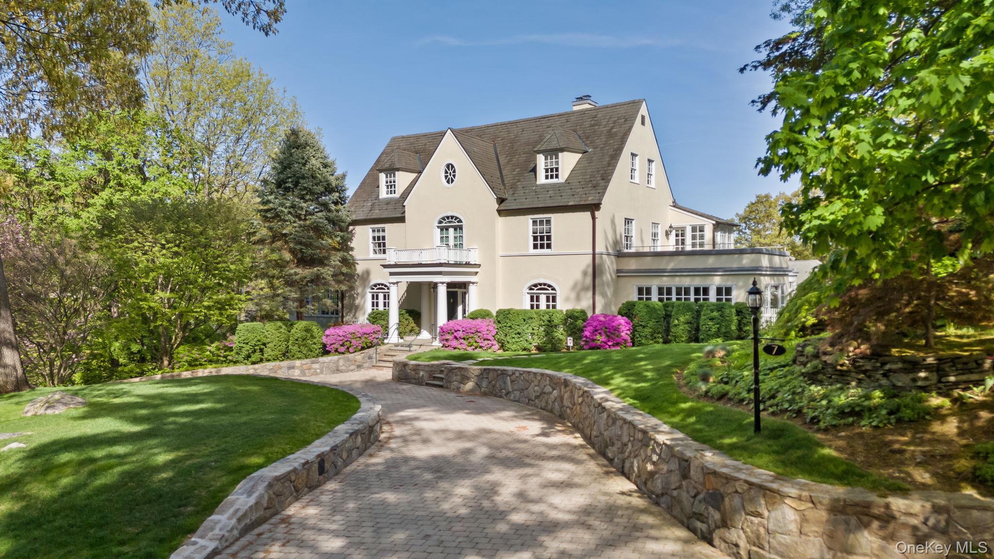 Timeless Elegance in Bronxville’s Lawrence Park! Welcome to 7 Plateau Circle West, one of Bronxville Village’s most treasured homes. Ideally located within walking distance to the train, Village center, and the renowned Bronxville School, this magnificent 1918 Colonial sits gracefully on a half-acre in the heart of the cherished Lawrence Park historic district.

Beautifully restored and thoughtfully enhanced, this distinguished home offers remarkable curb appeal and a grand entrance foyer that immediately sets a welcoming tone. Inside, rich architectural character shines through at every turn, with three fireplaces (two gas and one wood-burning), exquisite millwork, and oversized windows that flood the interiors with natural light.

Designed for both formal entertaining and comfortable daily living, the first floor features expansive principal rooms, a gourmet kitchen, and an inviting family room that opens to an outdoor private terrace with a built-in gas grill—perfect for seamless indoor-outdoor living. The redesigned outdoor spaces also include newly reclaimed yard space, offering room to play, relax, or entertain.

Upstairs, the primary suite provides a true retreat with refined comfort including a Juliet balcony, walk-in closet, balcony for enjoying sunset views and a spa-like bathroom. An additional suite provides a sitting room and access to another stunning balcony. There are four bedrooms and three bathrooms which complete the upper levels. The fully finished lower level offers ample versatile living space for a playroom, gym, or home office as well as an additional balcony and walk-out access. Completing this rare offering is a circular driveway, lower-level parking area, a two-car attached garage with storage, a whole-house generator, and every modern amenity, all just steps from the best of Bronxville Village living.