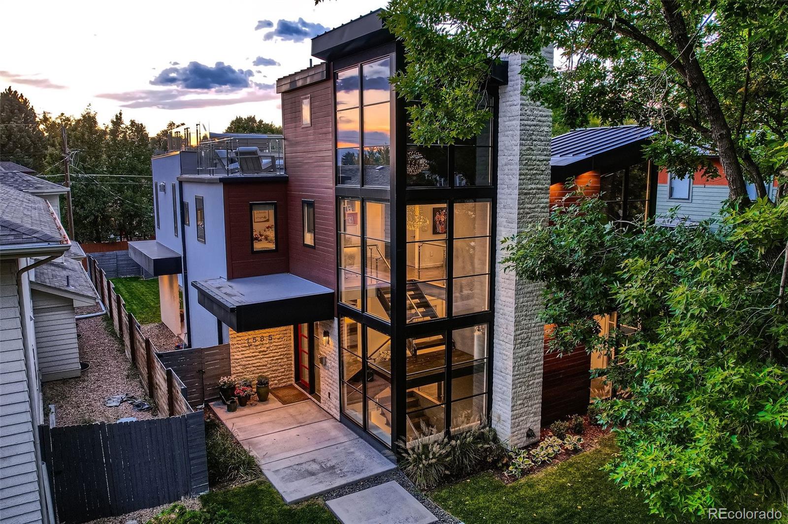 Luxurious custom home designed and appointed unlike anything you will see in Cory-Merrill.  Exterior has dramatic roof lines with three-story glass entry and floating staircase that fills the entire home with natural light. Three-story home with fully finished basement, third floor entertaining loft and spacious rooftop deck with mountain views.   Luxurious marble and stone throughout the home.  Kitchen island and walls are Italian Statuarietto Venato book-match slabs with in-island seating for four making the kitchen both grand and beautiful but also a cozy space as well.  Adjacent the kitchen is a spacious living room with fireplace and stone from Spain Bronze Amani 3rd, comfortable formal dining room and unique entry room conversation area with custom built coffee bar and Art piece Brazilian Cosmos slab that has a special engineered structure to hold the weight.  Main floor bedroom / office with ensuite bath and walk-in closet.  Second level primary bedroom has seating area and gas fireplace with 4 book-match slabs of Palessandro Italian marble and primary bathroom shower walls are full book-match slabs of Italian Laca Maca Vecia Exotic slabs along with two guest bedrooms each with ensuite bath and walk-in closets.  Third level loft entertaining room with adjacent wet bar and full bath along with access to rooftop deck.  Enormous entertaining rooftop deck with dining area, gas fire pit and seating and spa tub along with full panoramic view of the mountains. Basement is as well-appointed as the rest of the home with large family room, game spaces, entertaining kitchen, custom built glass and stone wine cellar along with a bedroom and full bath.  Comfortable back yard with covered patio and three-car garage.  Centrally located near Wash Park and Cherry Creek and a short walk to Cory Elementary.  Must see this home in person to fully appreciate. Showings begin Friday April 17th at 11am.