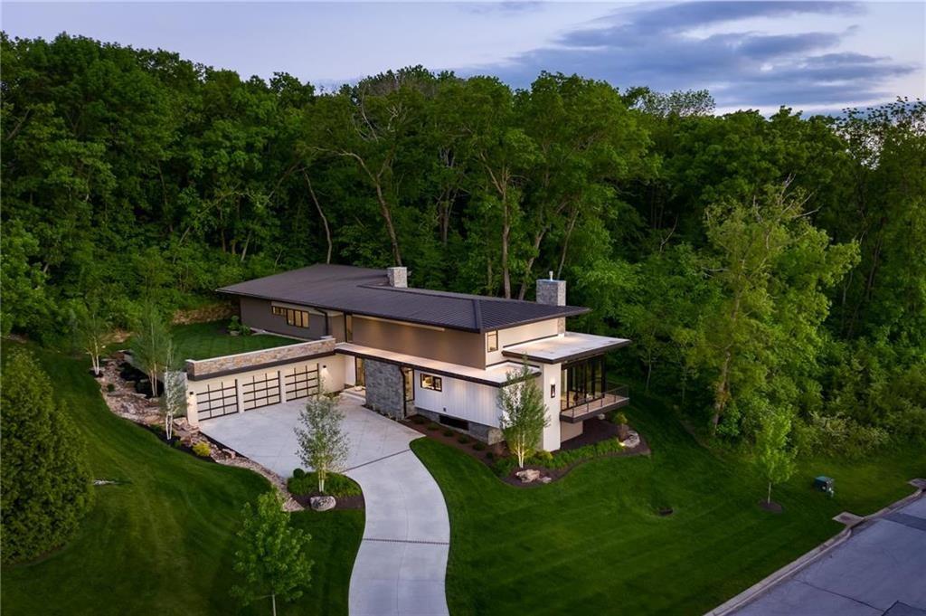 Exquisite 7,100 Sq Ft Modern Estate in the gated Loch Lloyd. With amenities such as championship golf, state of the art fitness facilities, pickleball & tennis courts, a brand new luxury pool and lake make Loch Lloyd a Lifestyle worth experiencing. This breathtaking 7,100 sq ft residence in the exclusive Loch Lloyd community blends modern architecture with timeless elegance. Spanning three levels, it offers the ultimate in space, comfort, and sophistication. Featuring 6 spacious bedrooms and 5.5 bathrooms, this home is designed for both luxurious living and effortless entertaining. Expansive floor-to-ceiling windows and an accordion glass door flood the interior with natural light, seamlessly blending indoor and outdoor spaces. At the heart of the home, the chef-inspired gourmet kitchen flows into a sprawling great room, ideal for hosting or relaxing with family. The primary suite is a private retreat, boasting a spa-like ensuite bath with a steam shower, generous walk-in closets, and serene views. Throughout the home, ample storage ensures every detail of modern living is thoughtfully considered. Architectural highlights include a standing seam roof, a sustainable live roof system, commercial-grade finishes throughout, and an energy-efficient geothermal HVAC system. Outdoor living is elevated with modern hardscaping and a secluded forest backdrop, offering both privacy and tranquility. Additional features includes a three oversized garage and exquisite design details that make this home a true embodiment of modern luxury living in Loch Lloyd. Basement renovation completed adding approx 2600 sq ft. Owner/Agent