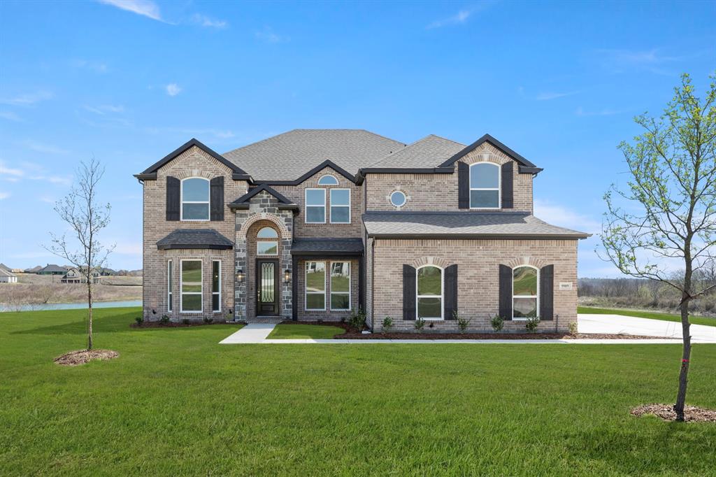 MLS# 21202374 - Built by First Texas Homes - Ready Now! ~ Discover this absolutely stunning five-bedroom, four-bath, two-story home with 4,081 sq. ft. of luxurious living space, set on a premium center water homesite with breathtaking panoramic views. Enjoy a private study with French doors, an open living area, and a dramatic 20 foot family room with a grand staircase and expansive windows. The gourmet kitchen opens to a covered patio pre-plumbed for a future outdoor kitchen, perfect for entertaining. The spacious downstairs primary suite features dual vanities, a garden tub, and a large walk-in closet. Upstairs offers a game room, media room, Juliet balcony, and four additional bedrooms. With a three-car garage and exquisite finishes throughout, this home is a must-see. Schedule your tour today!