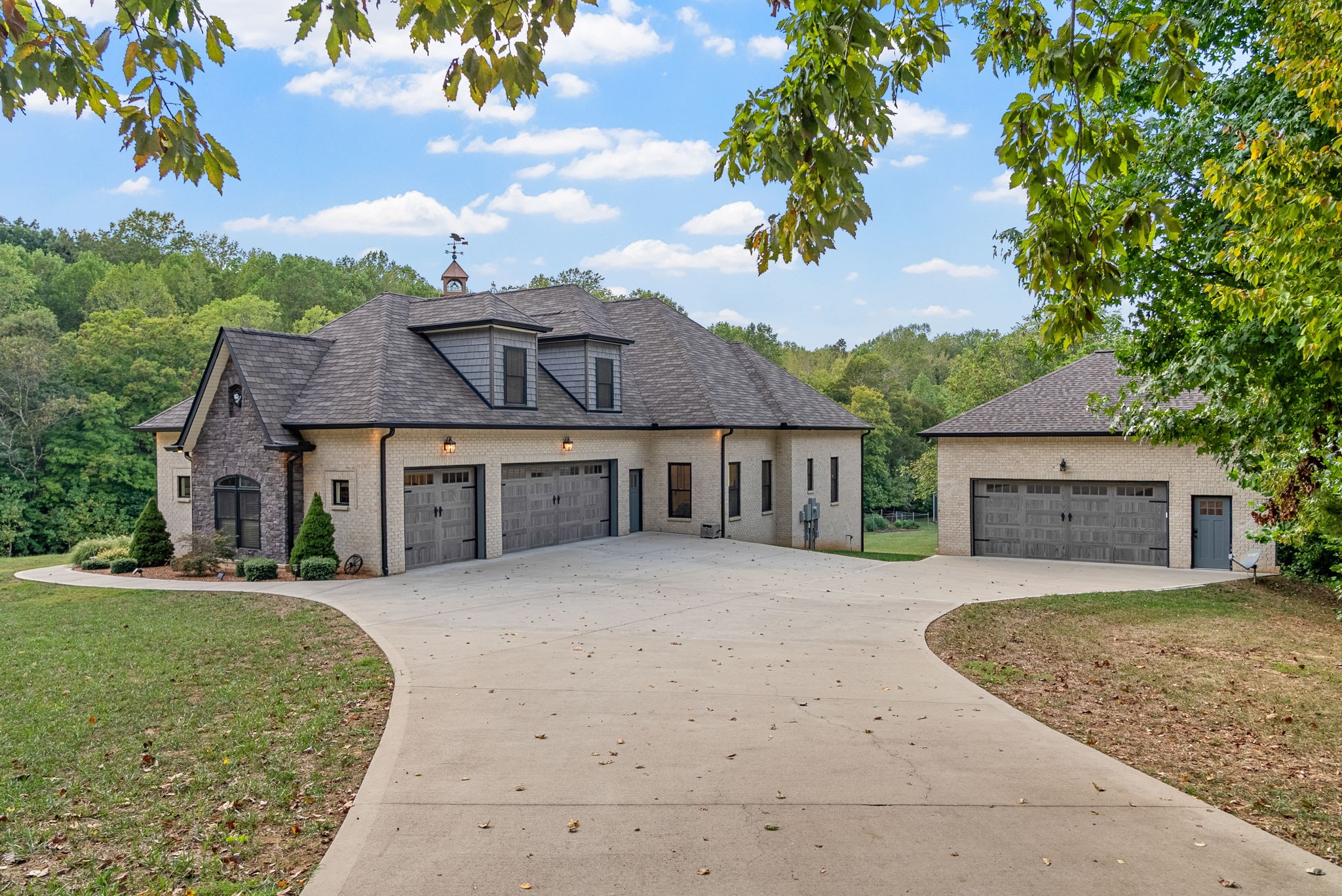 Nestled in the scenic Montgomery County countryside, this immaculate 15-acre farm is truly one of a kind. Enjoy luxury living in a custom-built home with expansive rooms, soaring ceilings, intricate trim work, and wood floors throughout. The gourmet kitchen features a double oven, gas cooktop, decorative tile, and a walk-in pantry with antique door.
The home offers four bedrooms, three bathrooms, 9-foot ceilings in every bedroom, secret play areas for children, all on the main floor, with a spacious bonus room and walk-in attic storage above. Enjoy cool nights on a private deck just outside the living room. Garage parking for five vehicles, a 30x50’ workshop with water and electricity, and a multi-generational tobacco barn ensure ample space for hobbies and storage. Step outside to gorgeous gardens, professional landscaping, a pavilion with utilities, a treehouse overlooking the creek, and wooded acreage for hiking or hunting. The encapsulated crawlspace, tankless water heater, and safe room highlight the home’s modern safety and comfort. A property of this distinction - with perfection, comfort and where natural beauty align - is rarely available.