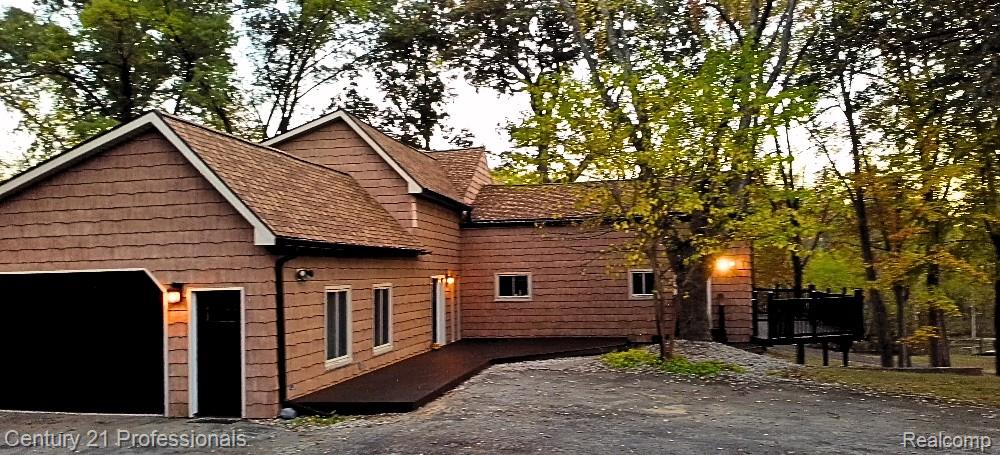 With the adjacent ranch home on its own .61-acre parcel now pending, this property is being offered as a newly configured 3-acre private estate, with pricing adjusted to reflect the main residence only.Inside, you’ll find new high-end flooring, fresh paint throughout, upgraded bathrooms, newer appliances, updated electrical and plumbing, and an EV Charger in garage—allowing for immediate move-in with confidence.The thoughtfully designed layout features two primary suites, including a highly desirable main-floor option, along with a spacious upper-level retreat with private balcony. The finished walkout lower level adds exceptional versatility with a large family room, additional bedroom, full bath, office, and flex space—ideal for multigenerational living or work-from-home needs.A dedicated theater room with projector, surround sound, and seating creates a true in-home entertainment experience.Outdoor living is equally impressive, with a wraparound front terrace, expansive rear entertaining area, and peaceful nature views—all set within a secluded, private setting.Conveniently located near Oakland Christian, Oakland University, Notre Dame Prep, I-75, and M-59.A rare combination of land, water, and updates—now offered at a price point that is increasingly hard to find.