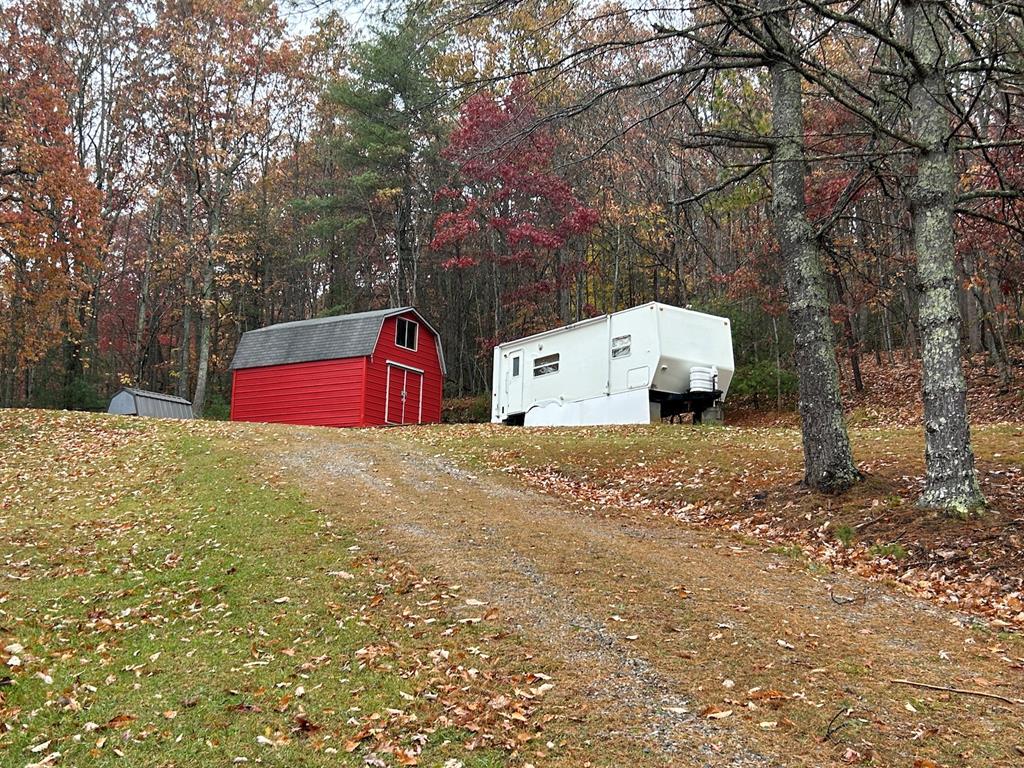 Escape to the peace and privacy of the country with this beautiful 6.11 acres property divided into 2 tracts that directly adjoins the Jefferson National Forest.  Property is mostly wooded and full of natural beauty and offers nature that is close to town.  You will find a well and septic already in place and ready for your home or cabin..But, in the meantime, stay in the nice camper that also conveys!!  To top it off, you have a large outbuilding ready for your convenience. Whether you're looking for a homestead, a weekend retreat, or an investment in a scenic mountain area, this property offers endless possibilities.