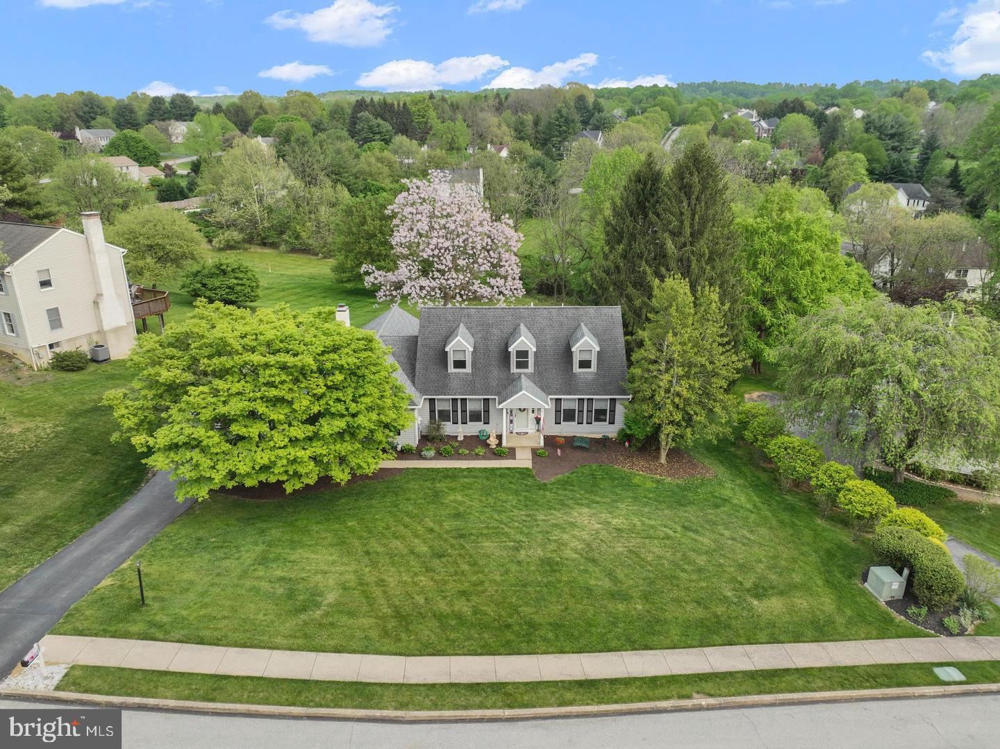 Seller is motivated for an offer and quick sale, Major price reduction on this lovely home. Set on a beautiful cul-de-sac lot backing to peaceful woods and open space, this expanded Cape Cod offers the perfect combination of charm, comfort, and versatile living space in the highly sought-after Downingtown School District. With a first floor primary bedroom which is so hard to find, this 4 bedrooms and 2½ bath home provides plenty of room to spread out and enjoy every season. SOLAR PANELS have been added and purchased by the sellers and will transfer with the sale to the new owner at NO COST. They have never hooked them up but they are ready to go.  From the moment you enter, you'll appreciate the traditional yet inviting floor plan, featuring wide-plank hardwood flooring, a welcoming two story foyer with hardwoods running into the formal Dining Room and into the formal living room or home office featuring glass French doors for privacy, this is perfect for working from home or creating a quiet retreat. The heart of the home is the gigantic and well equipped Kitchen, featuring granite countertops, an abundance of beautiful cherry cabinetry, a huge center island, and offers an open connection to the Family Room. With its vaulted ceiling, brick fireplace, and large rear windows, the Family Room is a warm and inviting gathering space with beautiful views of the private backyard. Just beyond the Kitchen is the impressive 20' x 20' Sun Room addition, filled with tons of windows to let in the sunlight and offering direct access through sliders to the rear deck and patio. Whether you're enjoying your morning coffee, hosting friends, or simply relaxing while taking in the wooded surroundings, this is sure to become one of your favorite spaces in the home. The first-floor Primary Suite provides convenience and privacy, featuring large closets and an ensuite bathroom . Head upstairs where the second floor offers three additional bedrooms and a spacious hall bath, giving everyone their own comfortable space. The finished walkout lower level adds even more versatility with multiple finished rooms, a slider providing access to the rear yard, and abundant storage.  PLEASE NOTE the carpets were just removed in basement due to an HVAC condenser leak which went unnoticed, that repair has been complete. A two-car garage provides additional convenience and storage and an EV charger. Outside, you'll love the updated deck, patio, beautiful lot, and peaceful wooded backdrop. Tucked away on a desirable cul-de-sac in Welsh Ayres, yet conveniently located near everything Downingtown has to offer, this special home truly has so much to enjoy. Come see for yourself—you may have just found the place you've been waiting to call home. This home is being sold in as is condition due to medical issues only. Welcome to inspections and negotiate a credit in lieu of repairs.