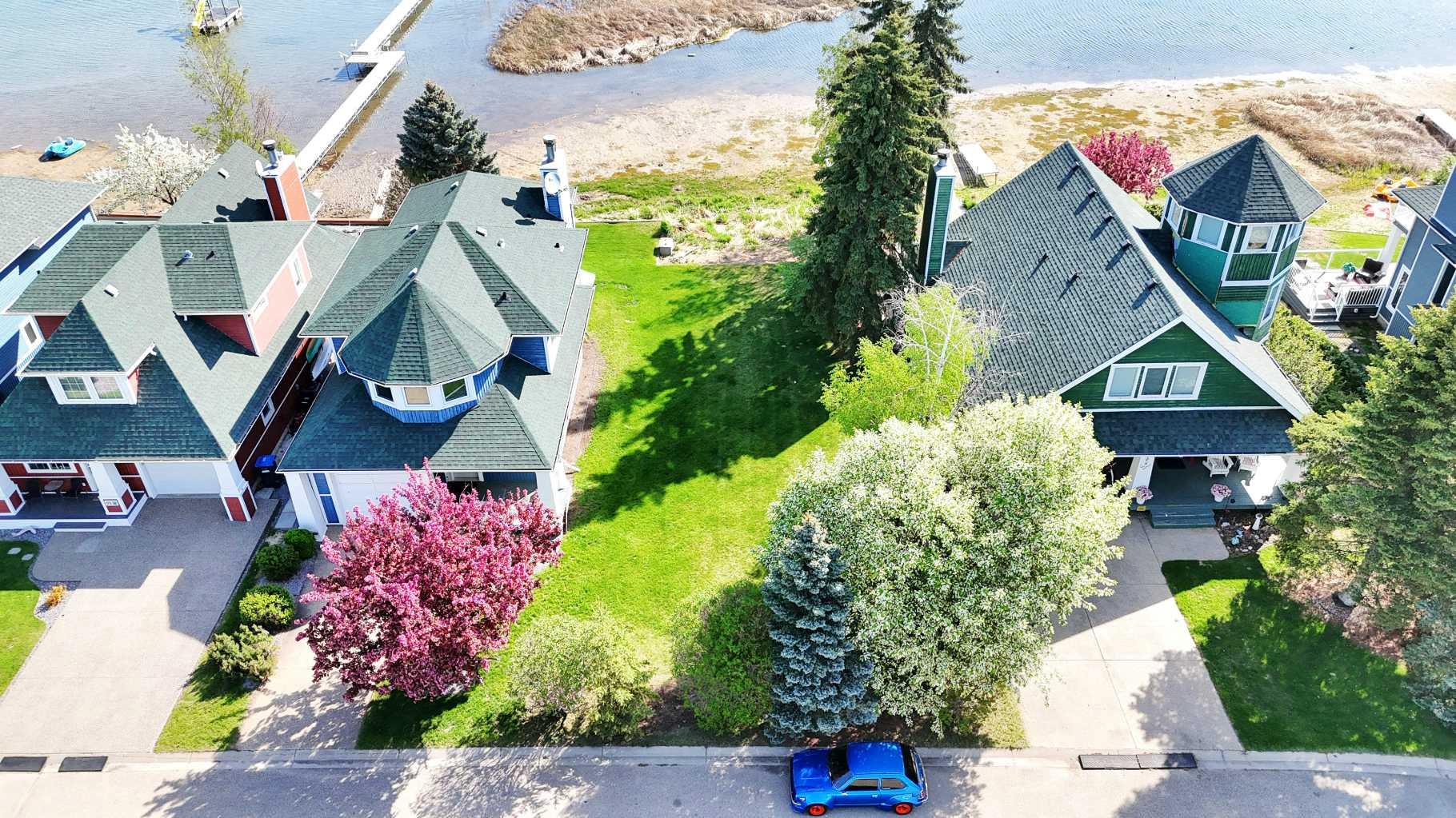 A rare find in Sylvan Lake’s coveted Marina Bay: this lakefront lot spans 3,738 sq ft and offers the ideal setting for your custom-built home. Positioned at the end of a quiet cul-de-sac, the property delivers sweeping water views, privacy, and a peaceful atmosphere just steps from the shoreline.Previously offered only as an optional add-on to the neighboring home at 180 Marina Bay Court, the lot is now available independently, unlocking a new opportunity for builders, dreamers, and investors alike. With mature landscaping and no structures to remove, this lot is construction-ready—providing a blank canvas for the lake home you’ve always envisioned.Ownership includes access to the private community marina, so you can step into a lifestyle of boating, paddleboarding, and waterfront recreation. Whether you're ready to build right away or planning for the future, this is a chance to create something truly special in a neighborhood known for its charm, character, and connection to the lake.Properties like this rarely come to market. For those seeking a prime location with water access, privacy, and long-term value, this Marina Bay lot checks all the boxes. Take the next step toward building your lakeside legacy.