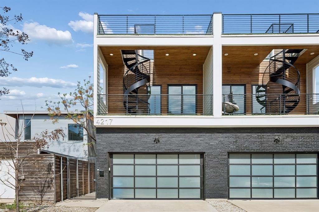 4217 Roseland Ave in East VillageNew construction duplex by Osman Custom Homes, completed 2022. Bold contemporary design in one of Dallas's most walkable neighborhoods — 75 Walk Score.Main level features soaring ceilings, white oak stained engineered hardwood floors, and an open layout built around a show-stopping 12-foot quartz waterfall island. Gas range, stainless appliances, white shaker cabinets, and matte black hardware. Sliding doors open to a private turfed yard with a gas fireplace.All bedrooms live upstairs. The primary suite includes a balcony, dual-vanity bath with LED mirrors, freestanding soaking tub, and rain shower wrapped in floor-to-ceiling stone. Four full bathrooms total, each with designer tile and quartz finishes.A gorgeous spiral staircase lead from the front patio to a private rooftop deck — perfect for entertaining with skyline views.Three turfed patios. Turfed yard. Zero maintenance, always green. Frosted glass garage doors. Modern fixtures and finishes throughout.East Village living at its finest.