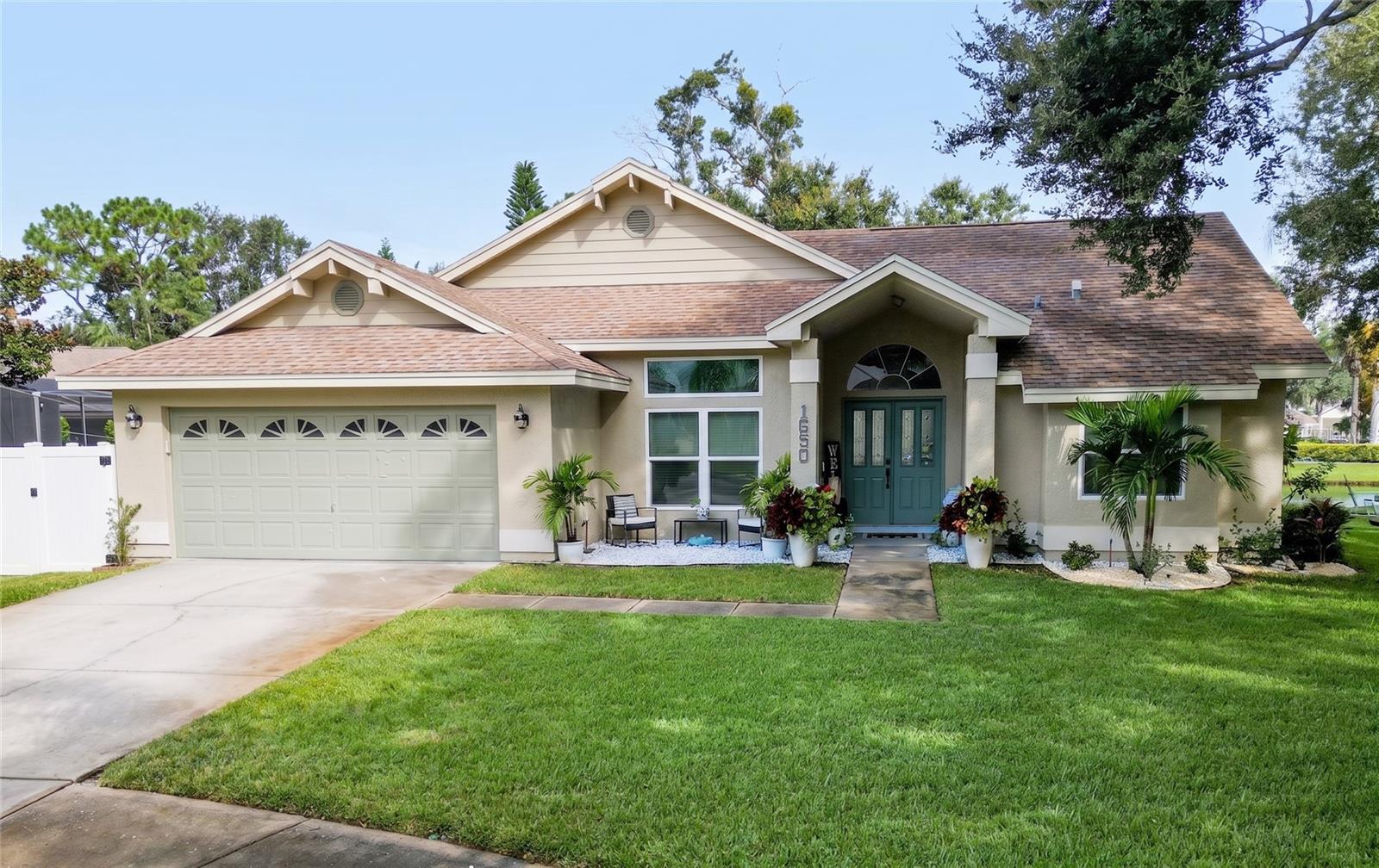 Welcome home to your fully remodeled Florida entertainer's paradise — minutes from the beaches, the Sponge Docks, and sunny Palm Harbor!Tucked away on a leafy cul-de-sac, this home sits on nearly one full acre — the best lot in the division and nearly impossible to find. It's like you have no neighbors at all.Built for entertaining, indoors and out. Multiple huge sliders wrap the home around your private oasis, opening to a massive covered lanai overlooking a stunning Pebble Tec pool with paver stone decking, a pool heater, and a full outdoor kitchen. Beyond the pool cage, enjoy your own private pond and sprawling yard.Inside, the home has been beautifully remodeled with an open-concept design connecting the dining room (with wainscoting), a sitting room, and a built-in bookcase wall with fireplace. Hardwood-style flooring, recessed lighting, and ceiling fans run throughout. The reimagined kitchen features glass-top cabinets, a large island, stainless appliances, and a butler's pantry with its own refrigerator, plus a Murphy door for extra flexibility. A second bedroom has a fun custom mural, and the laundry room has been fully updated.The primary suite offers a brand new custom closet with built-ins, plus a remodeled bath with granite dual sinks, a soaker tub, and separate shower; the second bath has also been remodeled.Behind the scenes: new electrical panel, blown-in insulation, irrigation system, and a garage workroom.With a living room, family room, and endless outdoor space, this is Florida living at its finest — come see it and start living your Florida dream!