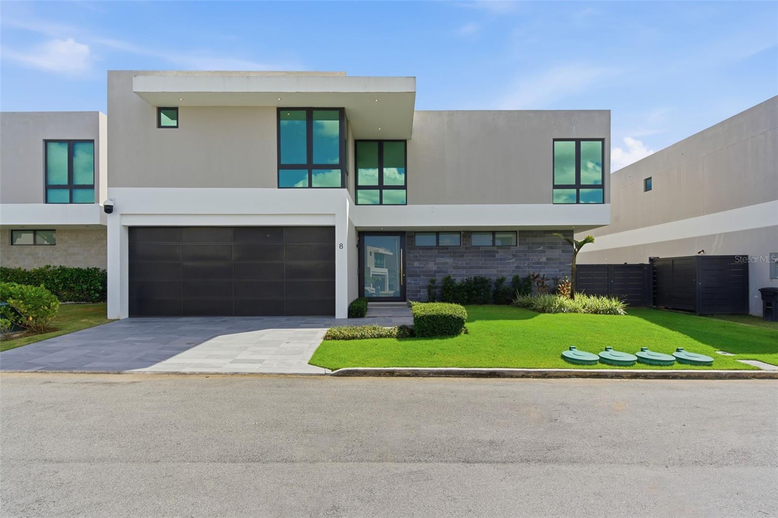 Live big in this contemporary Monaco Flex, where natural light and smart functionality come together in a layout designed for today—and adaptable for the future. Featuring 4 bedrooms, 4.5 bathrooms, and approximately 3,317 sq ft of construction on a 468 m² lot, this residence delivers true spaciousness from the moment you arrive.On the first level, you’ll find a grand salon with 18-foot ceilings and expansive windows that seamlessly connect the living, dining, family, and kitchen areas in an open-concept design—ideal for entertaining or everyday living. The standout feature is the ground-floor FLEX space, complete with a full bathroom and walk-in closet, perfect to use as a main-level primary suite, guest suite, private office, studio, gym, or whatever your lifestyle requires.Upstairs, the home continues to impress with a well-planned layout for comfort and privacy: the primary suite includes a walk-in closet and en-suite bathroom; a junior suite offers its own private bathroom; and two additional bedrooms with walk-in closets share a Jack & Jill bathroom. Modern touches like open views to the first level and glass railings elevate the home’s contemporary feel and sense of openness.Offered fully equipped and move-in ready: 7 inverter A/C units, a 25 kW generator, a 500-gallon water cistern, a state-of-the-art water purification system, a security camera system, and upgraded tile finishes throughout.Riviera Parkview offers exclusive resident amenities: pool, gym, activity rooms, tennis courts, beach tennis, basketball court, playground, and 24/7 security. Conveniently located near San Juan Metro, restaurants, shopping centers, private schools, and Bayamón Golf Course.Schedule your private showing today.