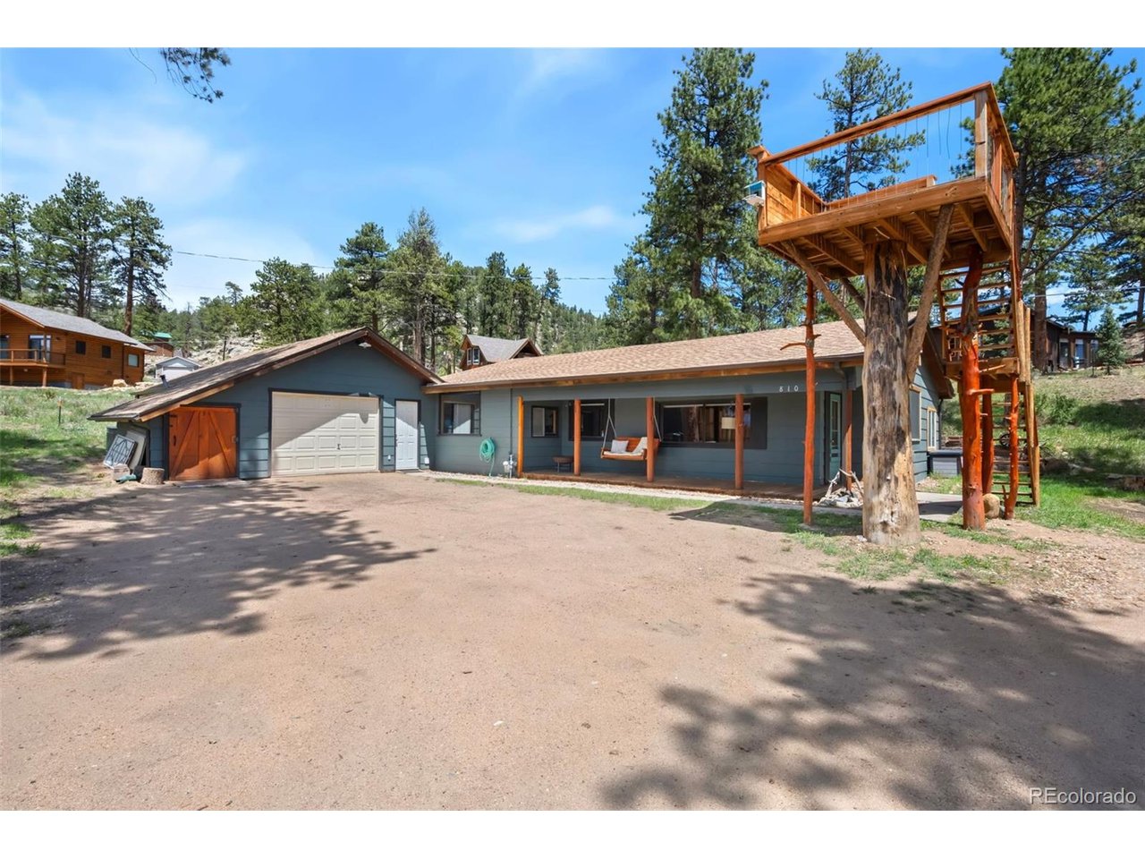 Surrounded by breathtaking scenery and just minutes from Rocky Mountain National Park and downtown Estes Park, this year-round mountain retreat is a dream come true for those seeking mountain serenity with modern comforts. Wake up to picture-perfect views of Long's Peak and Twin Sisters, where every sunrise and sunset feels like a postcard-worthy moment. The home has received numerous updates including fresh exterior and interior paint, blending rustic charm with a polished, updated look. The open and sunlit living space features warm Knotty Pine accents and a stunning moss rock fireplace, an inviting spot to unwind after a day of adventure. The recently remodeled kitchen is equipped with newer appliances, tiled backsplash, and live edge countertops, perfect for preparing meals and entertaining guests, with easy access to the dining area and living room. The garage has been thoughtfully transformed into a recreational space, offering flexibility for games, hobbies, or simply relaxing with friends and family. Outside, embrace the beauty of the great outdoors on your own raised observation platform. This unique feature allows you to experience nature up close, where wildlife sightings are a regular occurrence, and the tranquil surroundings can be enjoyed in peace. Additionally, the flagstone patio offers another vantage point to delight in the captivating views that envelop the property. Artisan fairy steps and a new water feature add to the character and charm of the outdoor living space. Whether hosting a barbecue, enjoying morning coffee, or enjoying the breathtaking scenery as you soak in the hot tub, this patio serves as a constant reminder of the enchanting Colorado lifestyle. The 100-year-old stone potato cellar adds a unique, historic aspect to the land, and the detached shed is the perfect spot for creative hobbies or storing your gear.