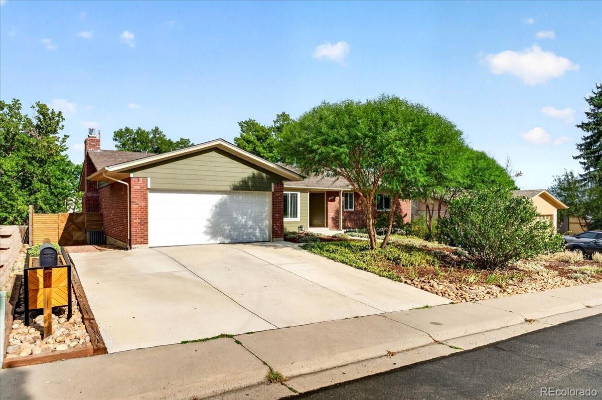Some homes are remodeled. This one was transformed. Set in coveted Green Mountain, this exceptional 5-bedroom, 3-bath walk-out ranch blends elevated design, thoughtful detail, and an unmistakable Colorado lifestyle. A kitchen with personality: the heart of the home features rich sage-green cabinetry, striking granite countertops, a generous center island w/ gas cooktop & statement range hood, SS appliances, and classic subway tile. Custom glass-front cabinetry, built-in wine storage, and a beautiful wet bar add character & make entertaining effortless. The result is sophisticated and distinctly its own. The light-filled main level continues with engineered hardwood floors, a spacious living room, and a warm family room with a fireplace and wood-beam ceiling. A dining room surrounded by windows features a custom ceiling detail. The primary suite offers an ensuite bath & barn-door walk-in closet, while two additional bedrooms and a full bath complete the main level. The finished walk-out basement offers two expansive rec spaces ideal for a home theater, game room, gym, and more. Two large bedrooms and a beautifully renovated bathroom with modern finishes, including a pet-washing station, complete the lower level. Outdoor living shines with a large new Trex deck overlooking a landscaped backyard with mature trees and stamped-concrete patio. A true standout, the 18x12 stand-alone workshop is a permitted shed equipped with 240V electricity and a dedicated heater, offering space for woodworking, an art studio, she-shed, or creative retreat. A two-car garage with epoxy flooring adds even more versatility. Updates include new windows, Hardie board siding, fencing, landscaping, flooring, interior and exterior paint, updated ceilings with popcorn removed, and recessed lighting. Ideally located with easy access to trails, Bear Creek Lake Park, Red Rocks, C-470, and I-70, this renovated home offers a a sophisticated design, warmth, and what Colorado living is all about.