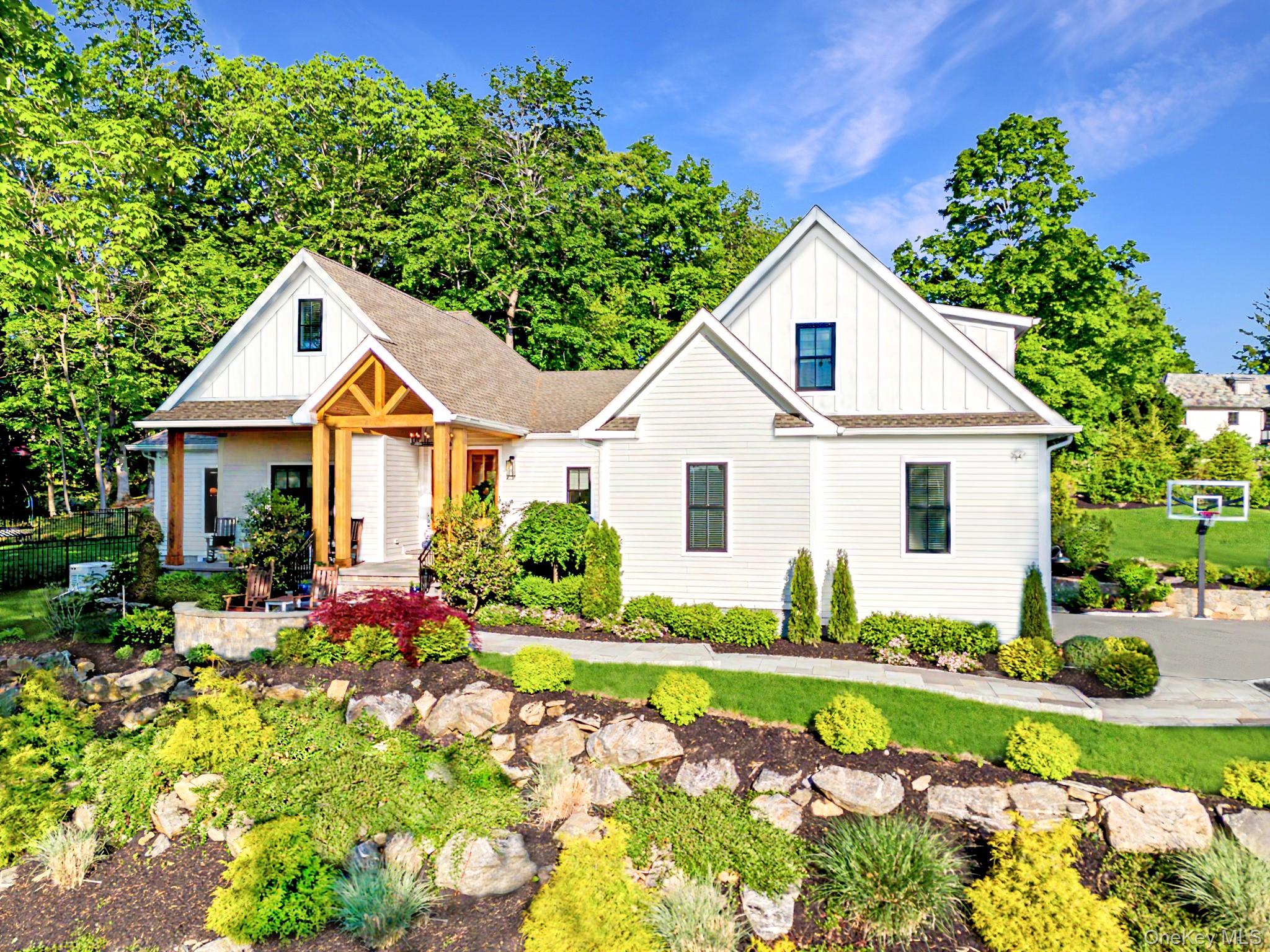 Tucked away on over two exquisitely landscaped acres in one of Chappaqua’s most prestigious enclaves, this exceptional newly constructed modern home redefines luxury living through a masterful blend of architectural sophistication, cutting-edge efficiency, and timeless elegance. Designed with a discerning eye and crafted with uncompromising quality, this magazine-worthy residence offers the ultimate turnkey lifestyle only moments from downtown Chappaqua, Metro North, and top-ranked schools. A dramatic arrival sets the tone as you enter through oversized custom doors into sun-drenched interiors framed by soaring 10-foot ceilings, expansive walls of glass, and wide-plank white oak flooring throughout. The home’s seamless open-concept design was thoughtfully curated for both grand-scale entertaining and intimate everyday living, creating a warm yet elevated atmosphere in every room. At the heart of the home is a spectacular chef’s kitchen worthy of a luxury design showroom, featuring premium professional-grade appliances, bespoke custom cabinetry, oversized quartzite island, designer lighting, and exceptional prep and storage space. Flow effortlessly into the breathtaking great room anchored by a statement fireplace and oversized sliders that open to a covered outdoor lounge, creating a true indoor-outdoor living experience. The primary suite is a private sanctuary rivaling a five-star resort, complete with a boutique-inspired dressing room and a spa-caliber bath featuring radiant heated floors, custom marble steam shower, soaking tub, and designer vanities. Generously sized ensuite bedrooms provide exceptional comfort and privacy for family and guests alike. The fully finished walk-out lower level elevates the home even further, offering an extraordinary extension of living space ideal for a private wellness retreat, gym, media lounge, golf simulator, wine tasting room, or entertainment venue. A striking custom wine display serves as a dramatic focal point and conversation piece. Every inch of this residence reflects a commitment to luxury and modern convenience, including geothermal heating and cooling, smart-home integration, premium fixtures and finishes, oversized heated garage space, and meticulously curated landscaping designed for both beauty and privacy. A rare offering that blends modern elegance, privacy, and convenience just under an hour from Manhattan. Come see a flawless fusion of contemporary design, superior craftsmanship, and effortless luxury set within one of Westchester’s most coveted communities today.