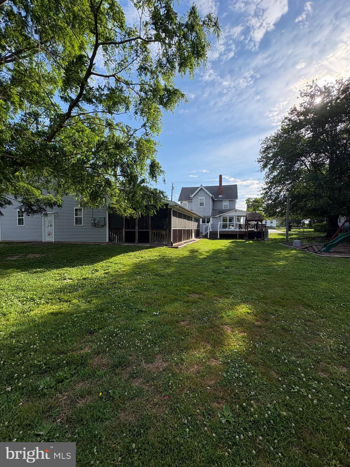 LOOKING  for a retreat inside our own property? Come Check this house out!! This spacious 2-story home features 3 bedrooms and 1.5 bathrooms, along with an extra-large detached garage. The property offers a large fenced backyard, a generous deck, and an outdoor patio bar with a half bath/ powder room—perfect for entertaining.Additional exterior features include two paved off-street driveways and plenty of outdoor space.Inside, you'll find a spacious eat-in kitchen, first-floor laundry, and a convenient half bath on the main level. The main floor also includes a large dining room, comfortable living room, and a versatile playroom or home office.The second floor features a large primary bedroom, two additional generously sized bedrooms, and a spacious full bathroom. Attic access is located on the second floor, and the finished attic provides additional living space that can be used as a bonus room, office, or recreation area. Don't miss out on this large house with expansive entertaining space in LAC with LOW TAXES!!
