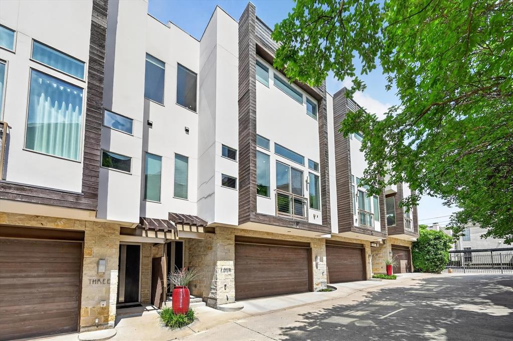 Stunning three-story townhome at 4230 Travis St #4 in a premier, walkable location near Katy Trail, Uptown, and top dining and entertainment. Featuring a striking steel floating staircase, soaring ceilings, and hand-finished oak hardwoods, the light-filled second floor offers an open living space and chef’s kitchen with European cabinetry, plus a private patio and powder bath. The first floor includes a guest bedroom and full bath with polished concrete floors and access to a fenced, turfed backyard with patio. The third-floor primary suite features a spa-like bath with dual sinks, soaking tub, walk-in shower, and an oversized custom closet, along with a private office. Additional highlights include a two-car garage, multiple outdoor spaces, hidden storage, and a stylish, swanky design throughout.