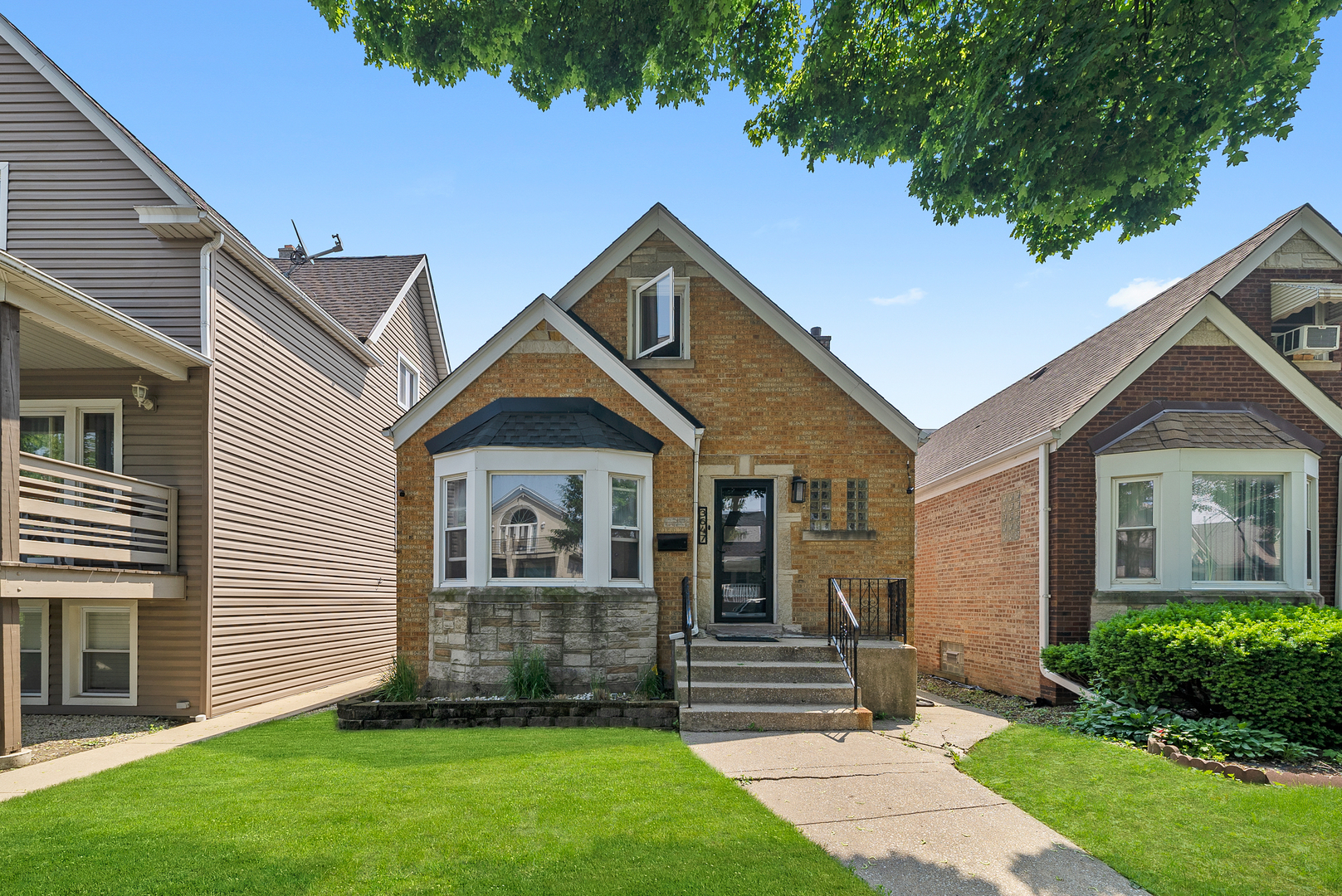 Charming brick 1.5-story English-style home with a finished attic and basement. Exceptionally well maintained with hardwood floors throughout the main level. The top floor features a spacious family room with a striking cathedral-style ceiling, along with a kitchen, bathroom, and bedroom. The lower level offers a second kitchen area, laundry room, bedroom, and additional storage. Mechanicals are in great condition.   Also, security cameras for the home are included! This home is a must-see!
