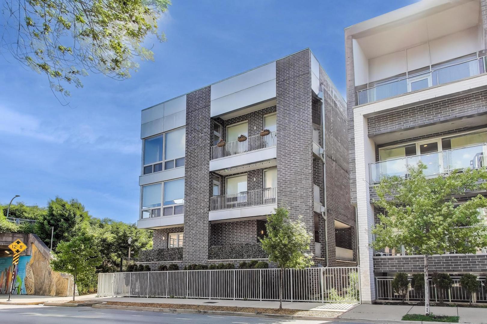 This is a truly special home not only in it's design but also it's location as it's overlooking the 606 trail, allowing for one to watch the world go by from the floor to ceiling windows, but fear not, no one can see into the home!  The cool lay out has the living and dining area opening on to a huge wrap around deck and covered terrace for phenomenal entertaining space. The adjacency makes this outdoor space so much better than a roof deck! This duplex home is extraordinarily cool with its extra wide floorplan designer finishes through out. Stunning kitchen with quartz counters, center island with overhang, heather grey wood cabinetry, white backsplash tiles, and stainless-steel appliances. A gas fireplace, built-in shelving and cabinetry would normally be the focal point of the living room are a gorgeous feature of the living room. Additionally there's the  convenience of a powder room on the main level. On the lower level are three large bedrooms, as well as a laundry closet with side-by-side washer and dryer and terrific storage. The primary bedroom is massive with room for a king-sized bed and furniture. There are also two build out walk-in closets. The spa-inspired primary bathroom with two separate vanities, heated floors, separate shower with rain head  and a bench, a standalone jetted tub, & separate lavatory room. Both the second and third bedrooms are very well proportioned, and the second bathroom continues the modern finishes that are reflected throughout the condo. To complete the perfect package, a garage parking space is included. Easy stroll to the California Blue line and all of the incredible restaurants including Bang Bang Pie Shop, Parson's Chicken, Lonesome Rose, various breweries, and so much more. This is a perfect home in a perfect location.
