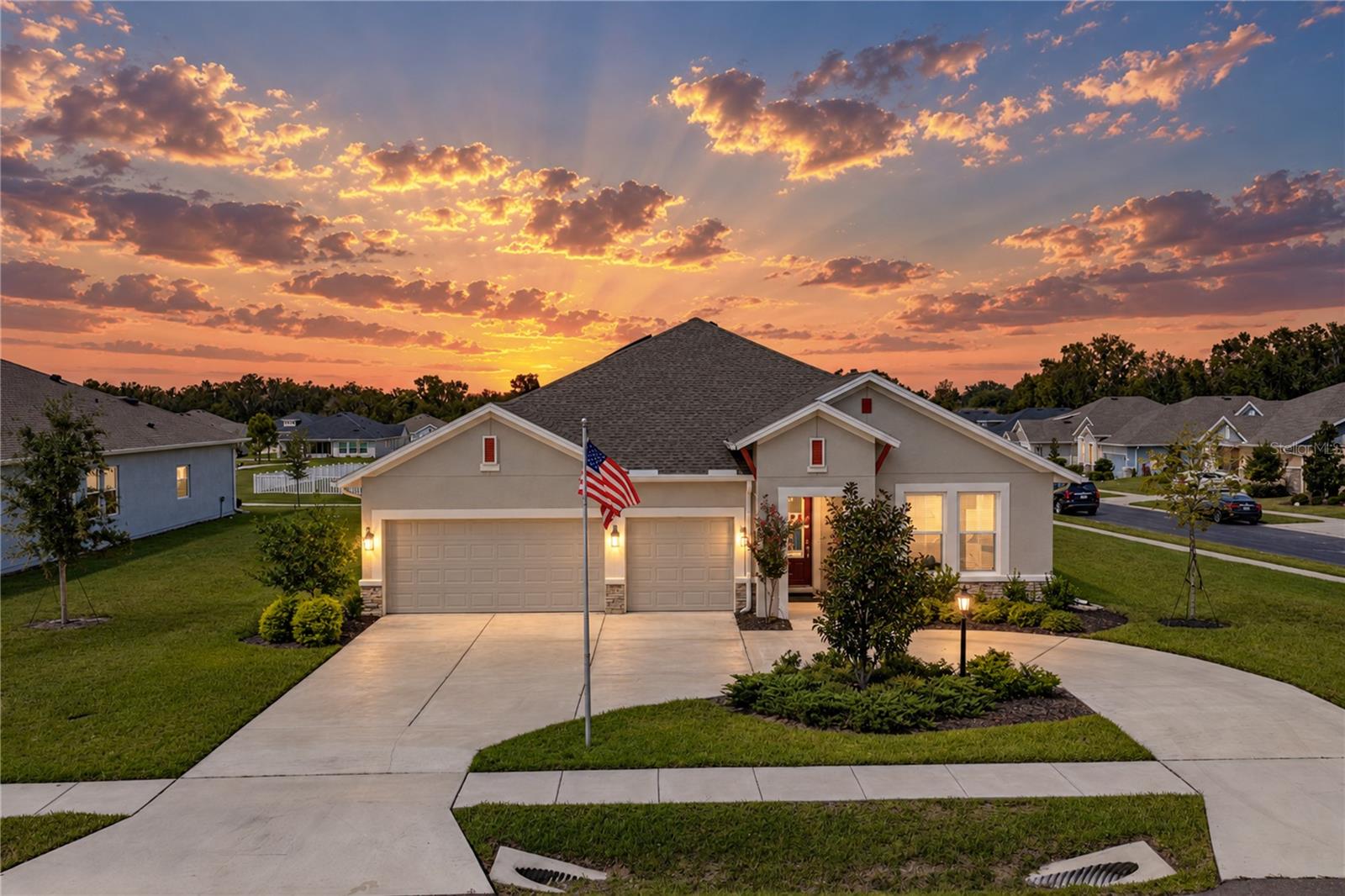 Resting within the Carmela community of San Antonio, the day ends beautifully here from the extended paver patio, where sunset and park views give this 2023 home a breathtaking backdrop. Set on nearly 1/3 of an acre, this 4 bedroom + office, 3 bath, 3 car garage residence spans 2,758 sq ft with paid-off solar panels, a triple-split bedroom plan, and the fresh feel of new construction without the wait. A convenient circular driveway makes the corner lot feel easy to navigate from the moment you arrive, while mature landscaping and a covered entryway lead into a bright, well-planned interior. Luxury vinyl plank flooring runs through the main living areas, connecting the spacious living room, dining area, and kitchen with a smooth, open feel. The gourmet kitchen was carefully curated with quartz countertops, Whirlpool stainless steel appliances, a decorative backsplash, pantry storage, and a generous central island with breakfast bar seating and pendant lighting. Its placement keeps the home chef close to the dining and living areas, with enough prep space and storage to make the kitchen feel comfortable and easy to move throughout. Behind double doors, the dedicated office gives you a private place for work, studying, or homework without sacrificing a bedroom. Privately split from the secondary rooms, the primary suite overlooks the backyard and includes an expansive walk-in closet, plus an ensuite bathroom with dual sinks, a quartz countertop, a private water closet, and an oversized walk-in shower. Bedroom 2 rests in its own wing near the front of the home, creating a comfortable guest suite with plush carpet, a ceiling fan, and a full ensuite bathroom with a tub/shower combination. Bedrooms 3 and 4 are placed near the third full bathroom and oversized laundry room, giving the layout smart separation for family, visitors, or multigenerational needs. Out back, the extended paver patio gives you space for outdoor dining, lounging, or enjoying the sunset with park views beyond the yard. Privacy hedges soften the setting, while the nearly 1/3 acre lot, 3 car garage, and paid-off solar panels add the kind of space, storage, and monthly savings that make this home even more appealing. Carmela places you in a desirable San Antonio location just minutes from major highways, Mirada Lagoon, local shops, restaurants, and nearby conveniences. Call today to schedule your private showing of this like-new home with a beautiful setting and valuable upgrades already in place!