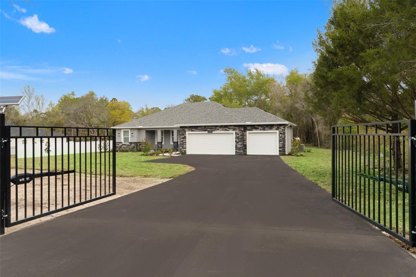 Welcome to this stunning Brand-New Estate designed by Santabarbara Homes LLC, The total package Gorgeous Home, Private Gated Entry with keypad, Beautiful private inground pool, and more all perfectly situated on nearly 2 acres in Pasco County. This beautifully crafted 3-bedroom, 2-bath Oversized 3 car garage residence offers the ideal blend of luxury, privacy, and modern convenience—all with easy access to Tampa.From the moment you arrive, you’re welcomed by your own private gated entry with keypad access, a sleek blacktop driveway, and brand-new wrought iron fencing, setting the tone for the quality and care found throughout the property.Step outside into your private backyard oasis featuring a gorgeous in-ground swimming pool surrounded by hand-selected travertine—perfect for relaxing or entertaining while enjoying breathtaking Florida sunsets. With nearly 2 acres, you’ll experience the space, privacy, and freedom that truly defines Florida living.Inside, discover the signature craftsmanship of Santabarbara Homes, built with durability, efficiency, and luxury in mind. Features include concrete block construction, hurricane impact windows and doors, foam board insulation with R30 blown-in attic insulation, and individual A/C returns in every room for enhanced comfort and airflow. The home is appointed with luxury vinyl plank flooring throughout, quartz countertops, soft-close cabinetry, and thoughtfully designed living spaces that create a true turnkey experience.Enjoy peace of mind with energy-efficient construction and materials specifically chosen for long-term performance in Florida’s climate.Ideally located just minutes from shopping, dining, and everyday conveniences, while still offering the peace and tranquility of country-style living. You’ll also enjoy easy access to Tampa via the Suncoast Parkway, along with nearby beaches, parks, and nature preserves. For outdoor enthusiasts, some of the best fishing on Florida’s Nature Coast is just a short drive away.This is more than a home—it’s a lifestyle.Come see the Santabarbara Homes difference.