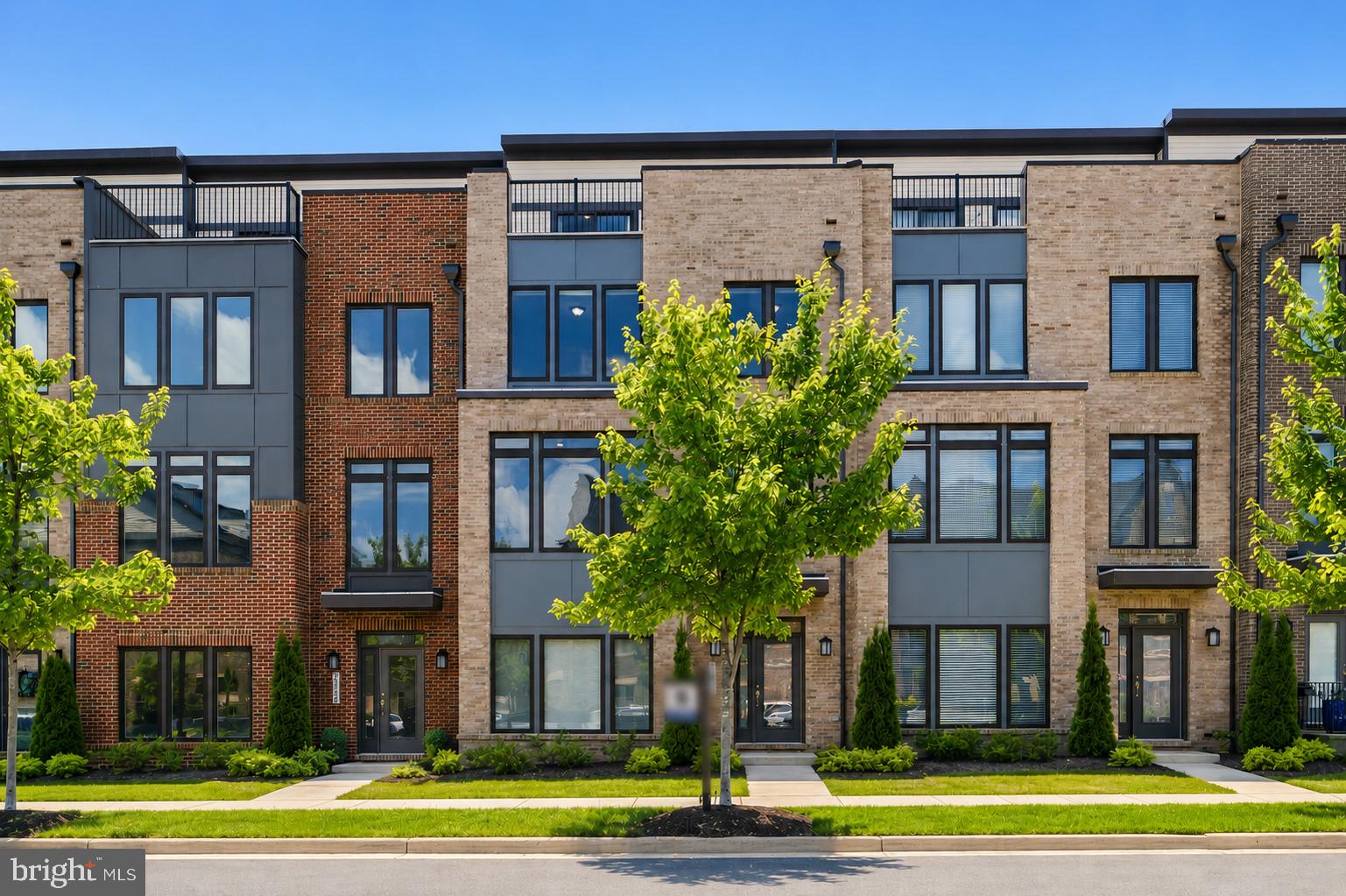 WELCOME TO LUXURY LIVING IN THE HIGHLY SOUGHT-AFTER METRO WALK COMMUNITY! Built in 2021, this stunning 4-level townhome offers over 3,200 square feet of thoughtfully designed living space featuring 4 spacious bedrooms, 3 full baths, and 2 half baths. The bright, open-concept main level showcases a gourmet kitchen with a large center island, stainless steel appliances, abundant cabinetry, and seamless flow into the dining and family rooms—perfect for everyday living and entertaining. Floor-to-ceiling windows fill the home with natural light, while the cozy gas fireplace adds warmth and charm.The upper level features a luxurious owner's suite with tray ceiling, dual walk-in closets, and a spa-inspired bath with double vanity and oversized shower. Two additional bedrooms, a full bath, and convenient bedroom-level laundry complete this floor. The impressive fourth level offers a versatile loft, an additional bedroom and bath, plus access to a spectacular rooftop terrace—ideal for entertaining, relaxing, or enjoying sunset views.Additional highlights include a rear-entry two-car garage, private balcony, and modern finishes throughout. Enjoy resort-style amenities including pools, clubhouse, fitness center, walking trails, playgrounds, and more. Unbeatable location just minutes from Ashburn Metro Station, major commuter routes, shopping, dining, and all that Ashburn has to offer. This is low-maintenance luxury living at its finest!