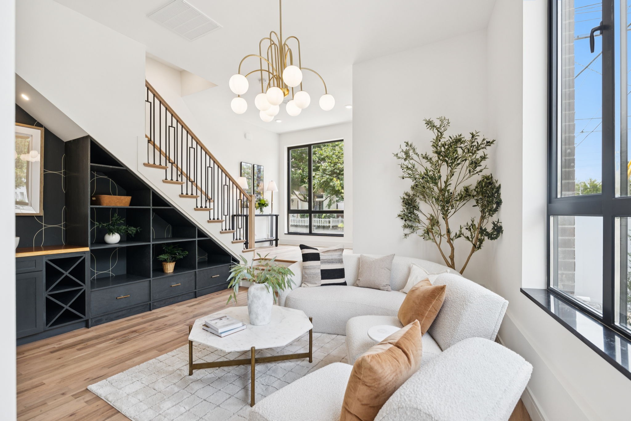 Welcome to EQ East, a modern collection of luxury residences in the heart of East Nashville. Just steps from popular restaurants, coffee shops, and local hotspots, this walkable location offers exceptional convenience.

Inside, you'll find a chef-style kitchen with quartz countertops and backsplash, ceiling-height cabinets, and an open-concept layout - perfect for entertaining or everyday living. Bathrooms feature large walk-in showers and high-end finishes, offering a spa-like experience at home.

Thoughtful design touches include custom accent walls, designer lighting, built-ins, and a main-level wet bar that adds both style and function. Enjoy an expansive wraparound terrace with downtown skyline views - ideal for relaxing or hosting guests.

Off-street parking in a secure gated lot adds peace of mind to this true lock-and-leave lifestyle.