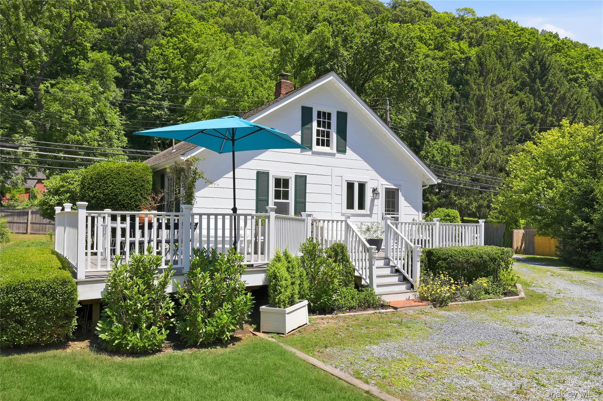 Nestled on a picturesque three-quarter-acre in the heart of Bedford Village, this charming country cottage blends historic character with thoughtful modern updates. The two-bedroom, (originally 3) one-bath home features antique wide-plank wood floors, quartz countertops, and an expansive deck overlooking beautifully landscaped gardens. A renovated accessory dwelling unit (ADU) offers exceptional flexibility with a full kitchen and bath. (an additional 282 sq ft.) Legally rentable, it's also ideal as a guest house, private home office or artist's studio.  Rich in local history, the property occupies the original site of Bedford's first schoolhouse and sits across from the historic stagecoach stop, offering an opportunity to enjoy the timeless charm of village living.