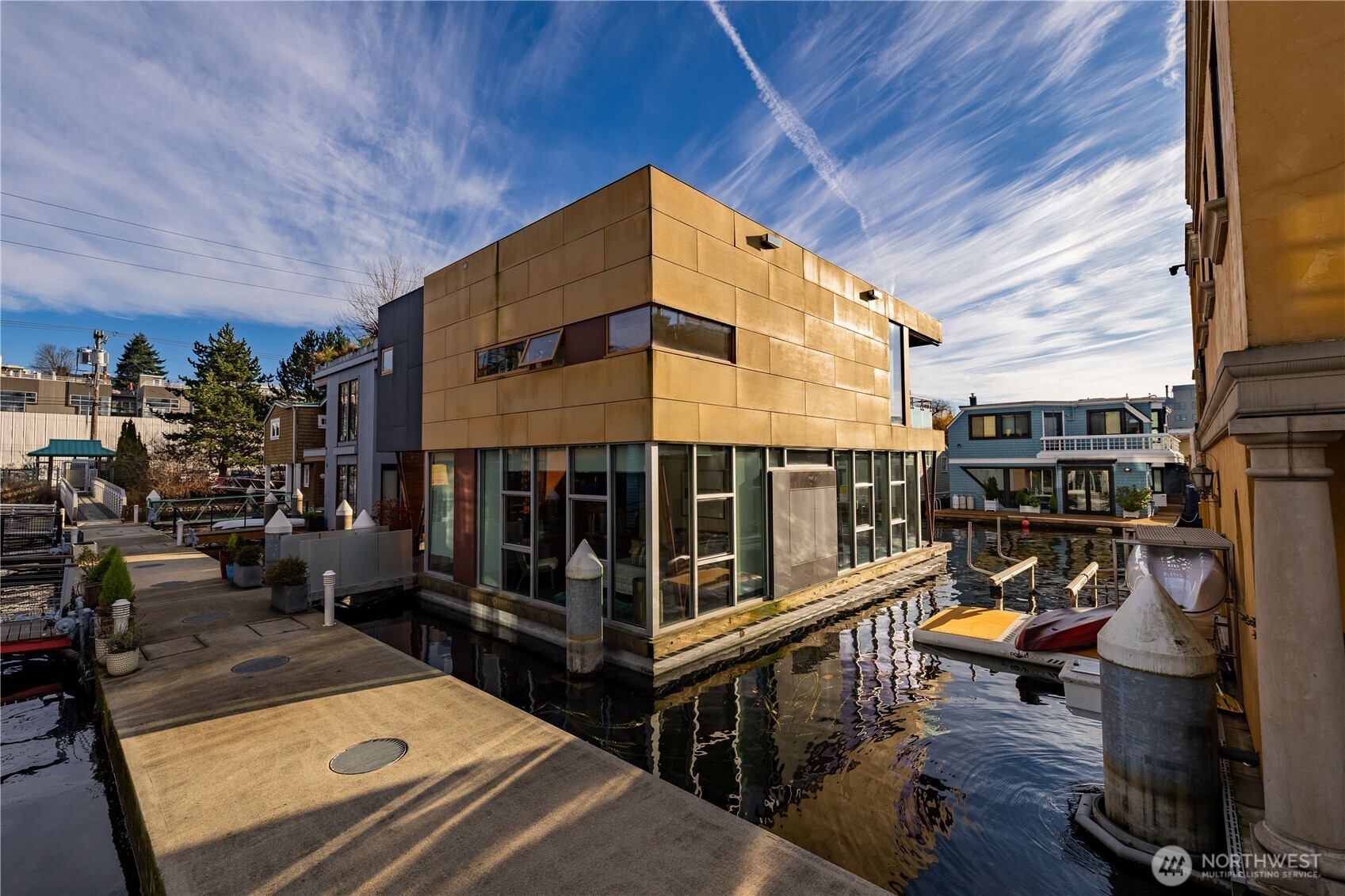 A stunning modern floating home by Vandeventer + Carlander Architects w/ sought after southern exposure on highly desirable dock is intentionally crafted to immerse you in its waterfront setting w/ sweeping views of Downtown Seattle, Olympics & Space Needle. Four levels of living including a roof top & basement w/ actual porthole windows, this home's sculpted form plays w/ light & perspective, offering both openness and privacy while maintaining a deep connection to the water. Features include a gated community, three view decks, a primary suite, two additional bedrooms and baths, an underwater lower level, solar power and parking. Dedicated parking space in gated lot and boat moorage along shoreside of home with remote control boat lift.