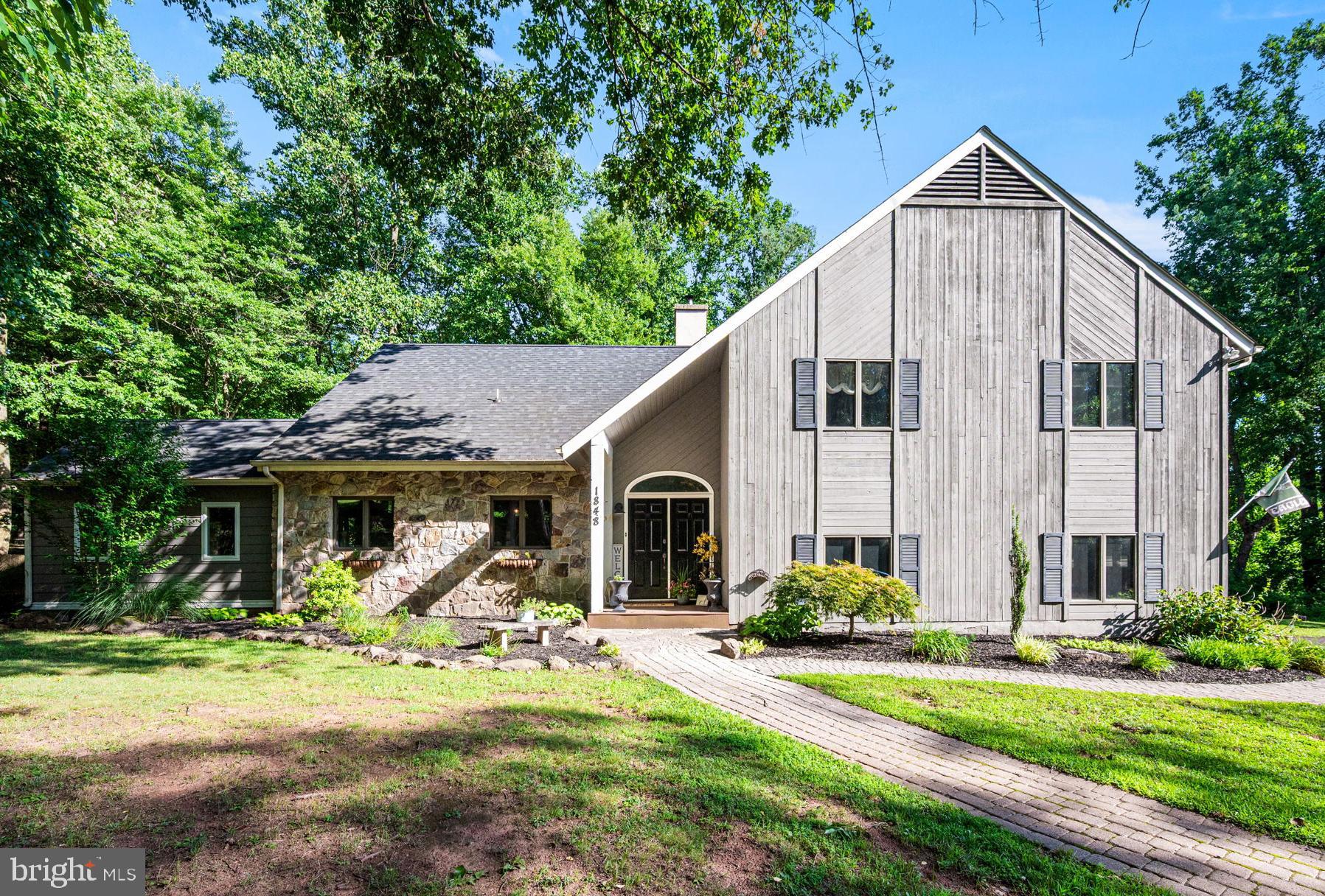 Tucked into a peaceful, park-like setting in desirable North Coventry, this striking cedar and stone contemporary proves that not every home has to look like the one next door. With tranquil pond views, mature landscaping, and spaces designed for gathering, relaxing, and making memories, this is the kind of home that feels like a getaway... without ever packing a suitcase.Step through the dramatic two-story foyer and into a home that's made for bringing people together. The expansive kitchen is the true heart of the home, featuring double ovens, extensive granite countertops, a pantry cupboard with convenient pull-out drawers, and enough cabinetry to make every small appliance happy. Whether you're hosting the holidays or just trying out a new recipe, you'll have room for it all.The breathtaking Great Room is ready to impress with soaring cathedral ceilings, a spectacular wall of windows that brings the outdoors in, and a floor-to-ceiling stone fireplace with a wood-burning insert that's just waiting for cozy evenings and hot cocoa season. Sliding doors lead to the wraparound concrete patio, making it easy to take the party outside. Fire up the grill, string up some lights, and you've got an entertaining space your friends may never want to leave.Looking for your favorite morning coffee spot? The sunroom, with its tile flooring and panoramic views of the surrounding landscape, might just become your new happy place.Upstairs, the primary suite feels like its own private retreat with a beautiful vaulted ceiling, a huge walk-in closet, and a spacious en-suite bath featuring a raised soaking tub, walk-in shower, and plenty of room to relax and recharge. Three additional bedrooms offer generous closet space and share a hall bath with a double vanity and tub surround.The finished lower level family room offers incredible flexibility with durable 18-inch tile flooring and double doors leading directly to a second concrete patio, and with the full bathroom on the lower level, this space could easily serve as a fifth bedroom, private guest suite, or in-law space while still leaving plenty of room to gather. There is also an enormous laundry room (with a chute) that's so much more than a place to do laundry, featuring abundant cabinetry, generous counter space for folding and organizing, and enough storage to keep life's clutter neatly tucked away.Outside, there's just as much to love. Shoot hoops on your very own half-court basketball court, spread out on the oversized driveway, or simply enjoy the beautifully landscaped grounds. A brand new roof gives you much needed peace of mind. A two-car attached garage and full attic storage provide plenty of room for all the practical stuff, while the convenient location - just minutes from Routes 100 and 424 - makes getting where you need to go a breeze. You are also just steps away from all of the beautiful Coventry Woods trails!Some homes simply give you a place to live. This one gives you room to gather, room to grow, and room to make memories for years to come.